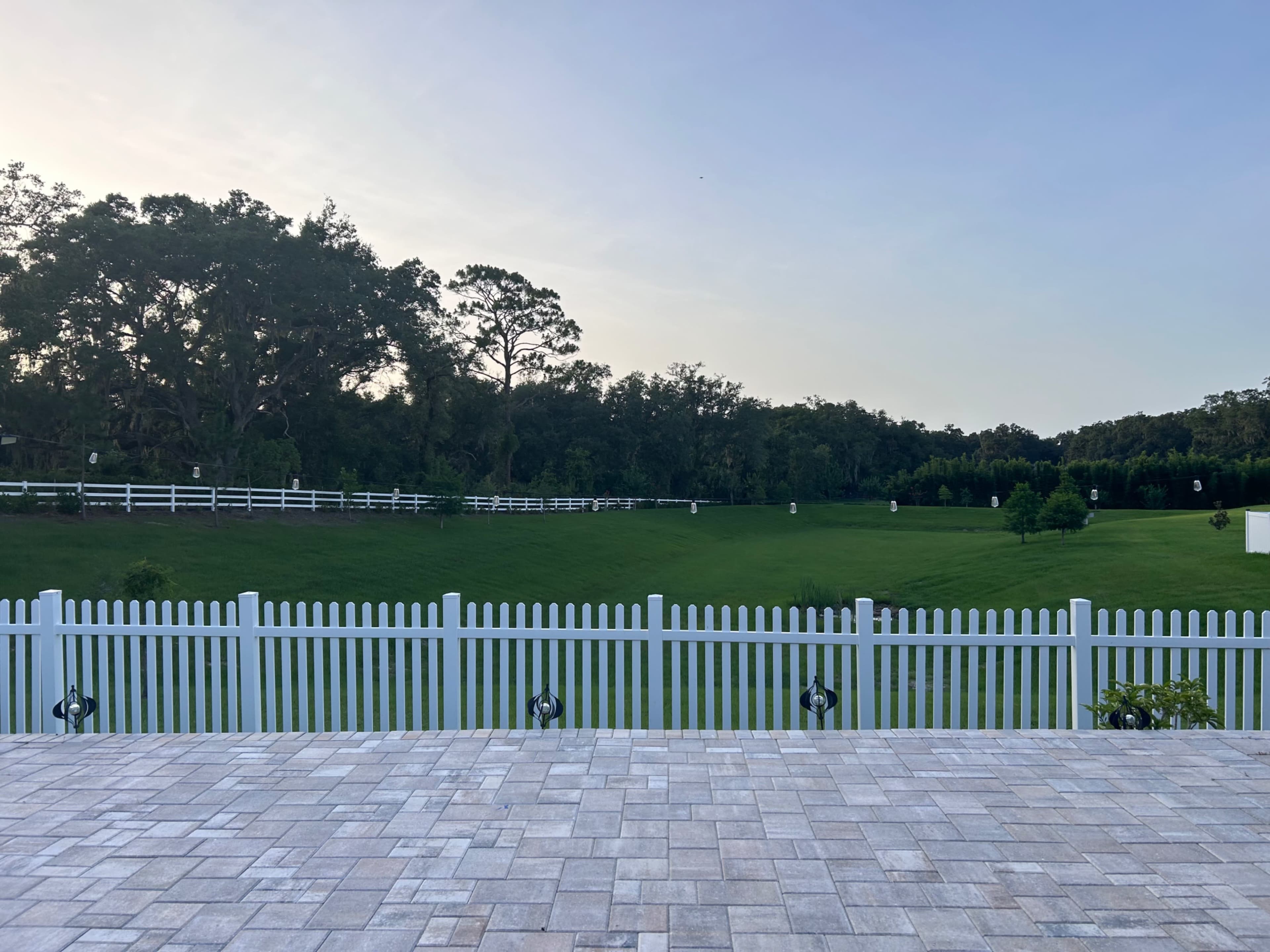 Charming Outdoor Photography Space with Greenery + White Picket Fence Backdrop Image in Leesburg, Okhumpka, FL