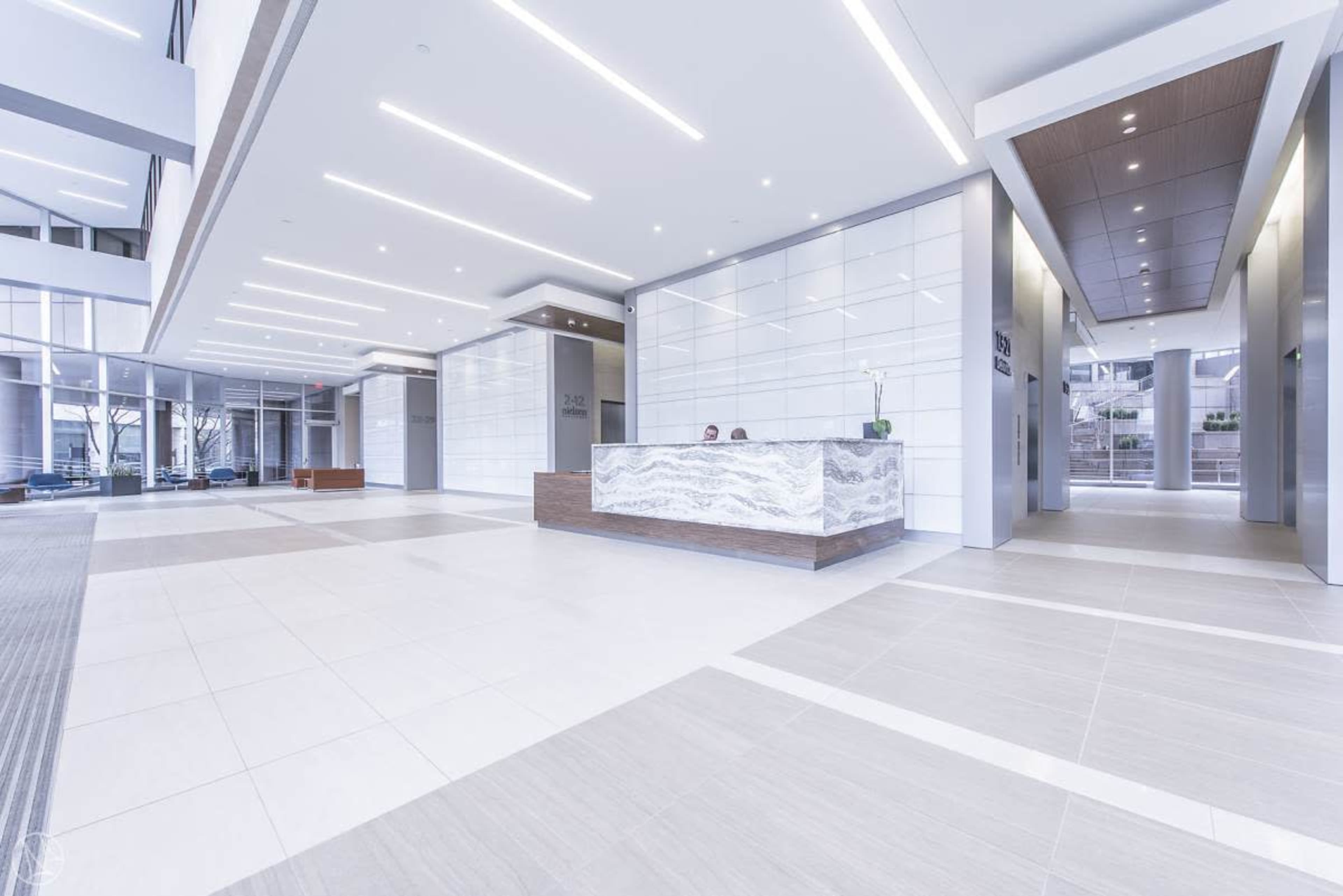 A modern reception area with a sleek front desk and well-lit surroundings.