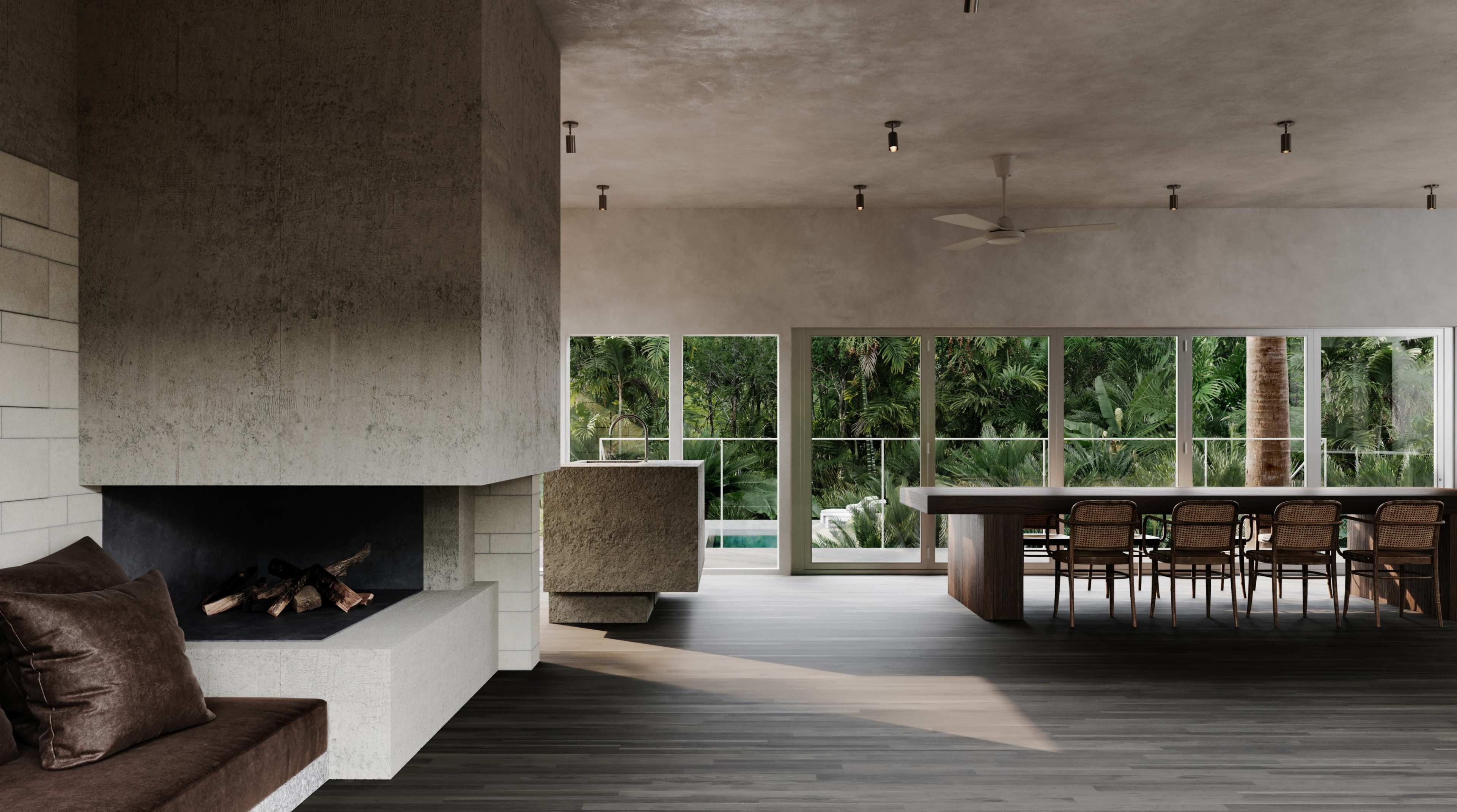 The image shows a modern interior space with a concrete fireplace, large windows overlooking greenery, and a dining area featuring a long wooden table and chairs.