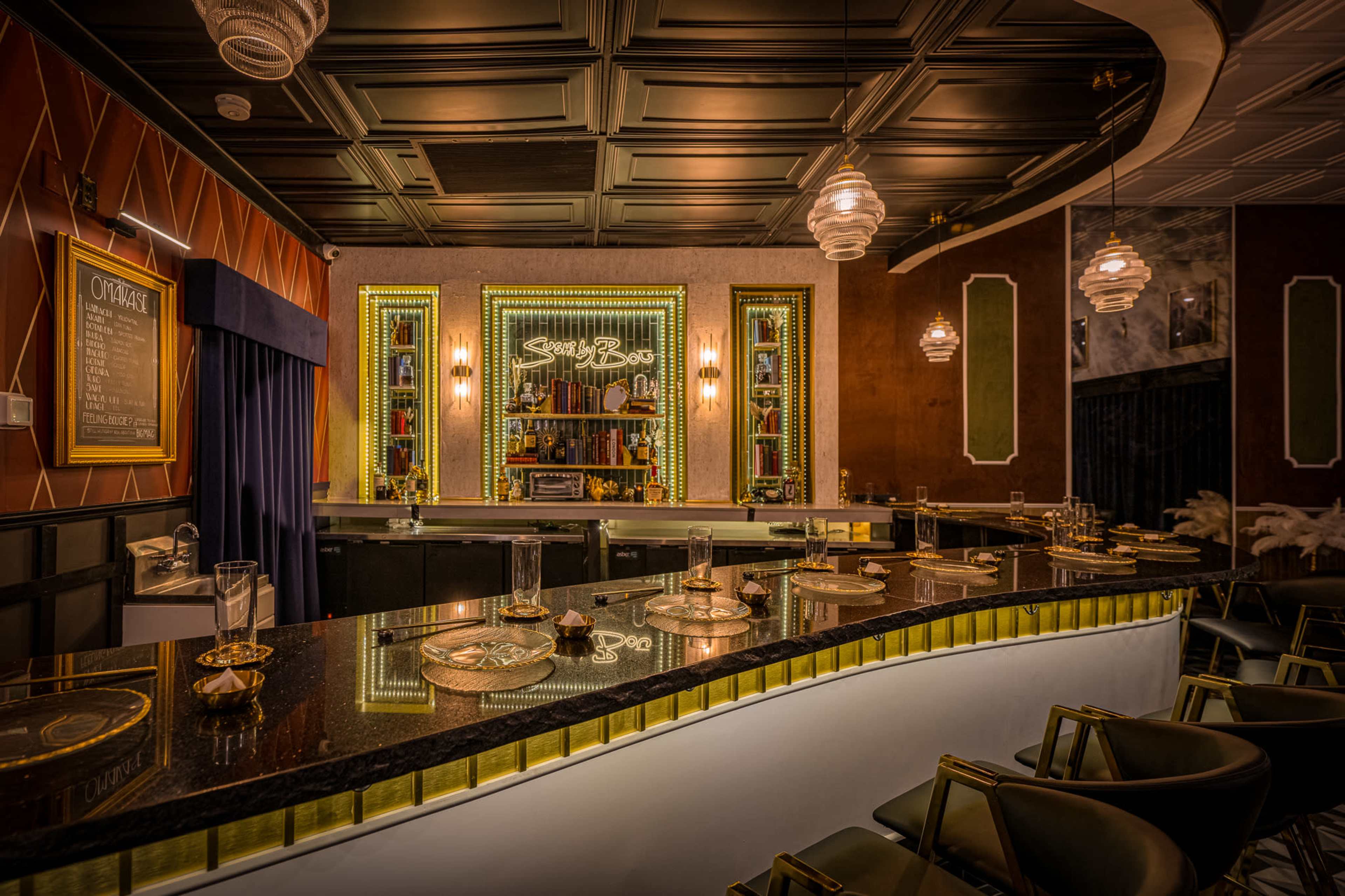 The image features an elegantly designed bar area with a curved counter, illuminated shelves displaying various bottles, and stylish seating arrangements.
