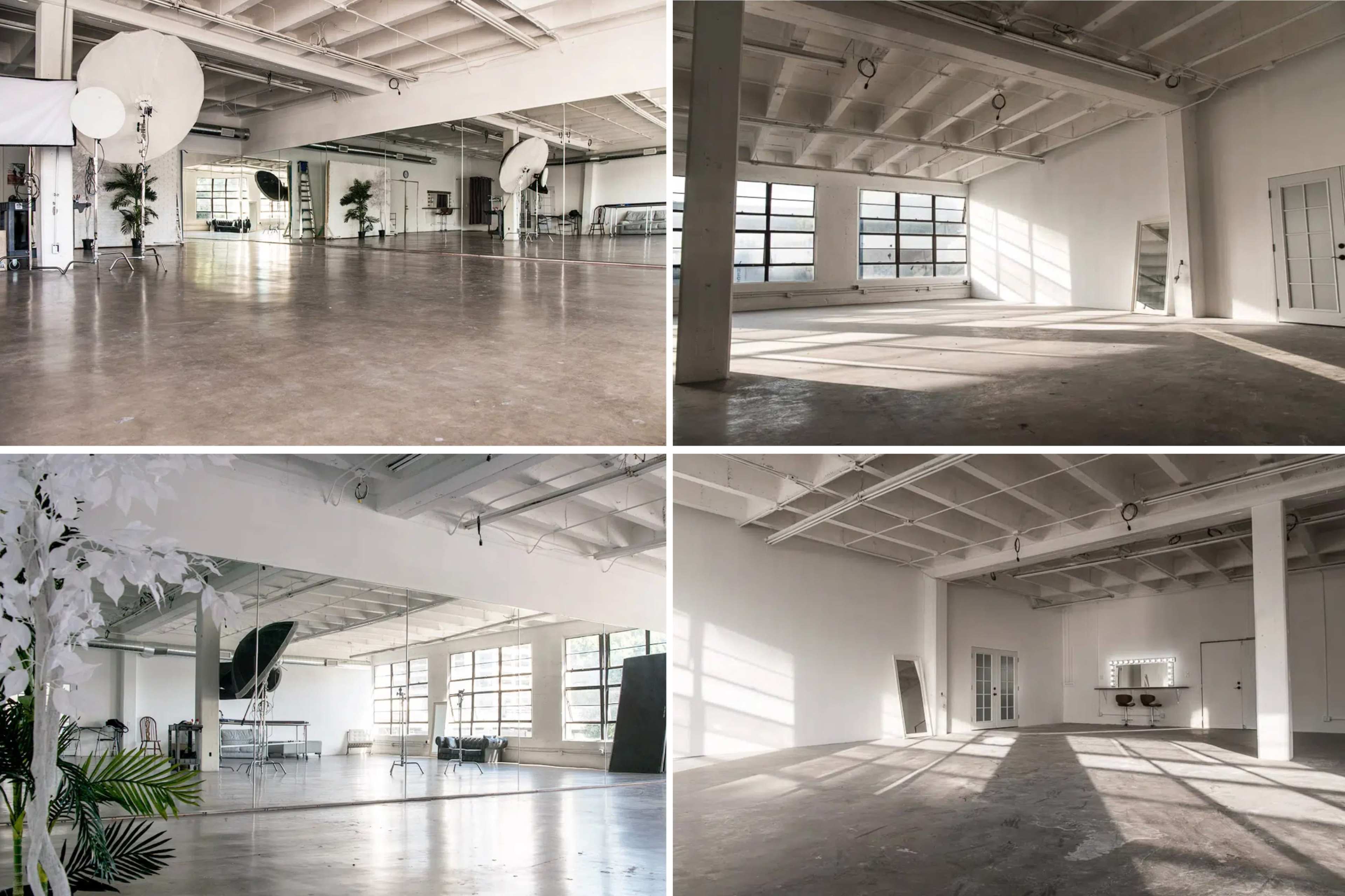 A spacious, well-lit studio with large windows, neutral-colored walls, and minimal furnishings in different sections.