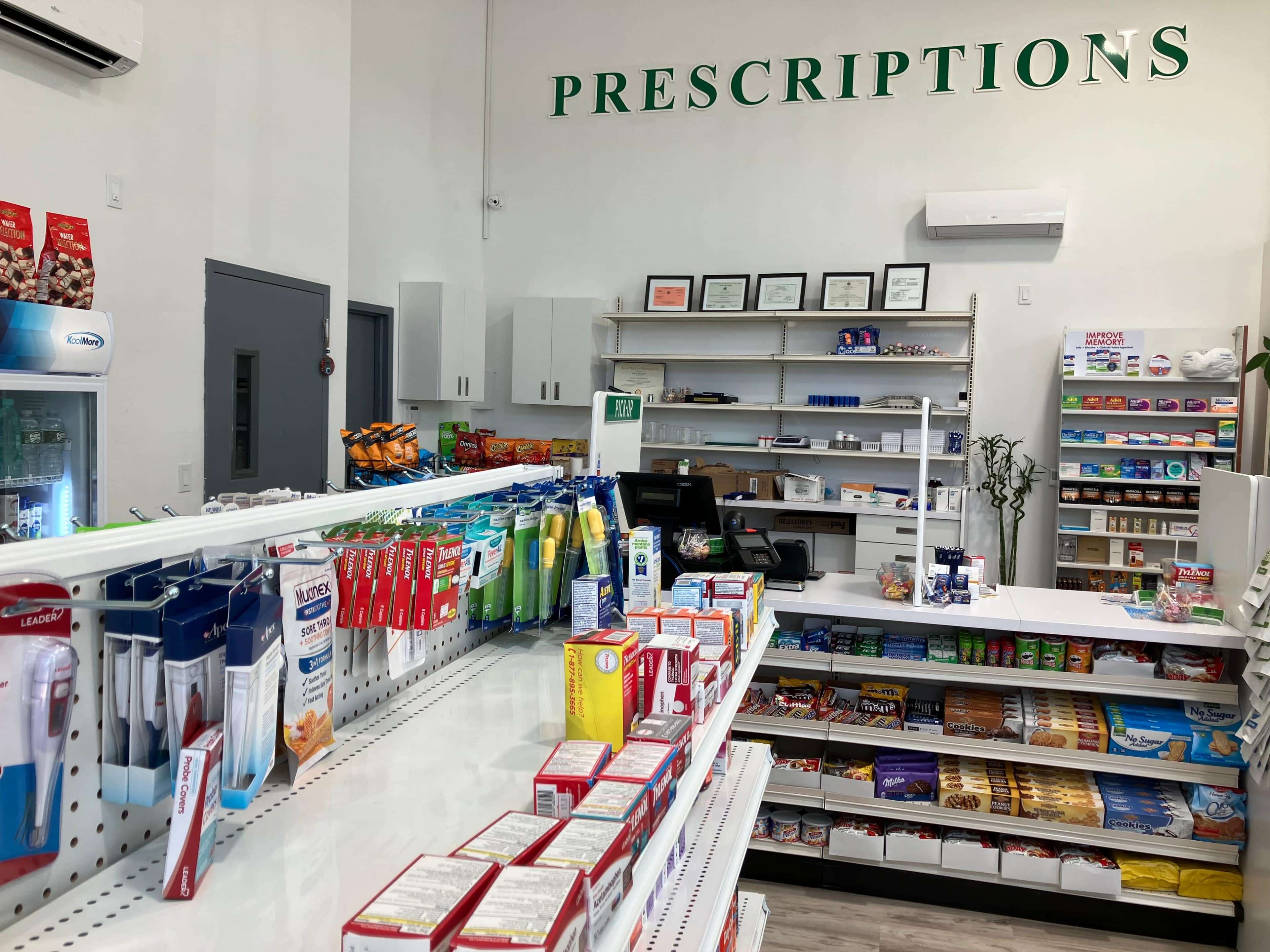 The image shows an interior view of a pharmacy with a focus on the prescription area, featuring organized shelves stocked with various health products and snacks.