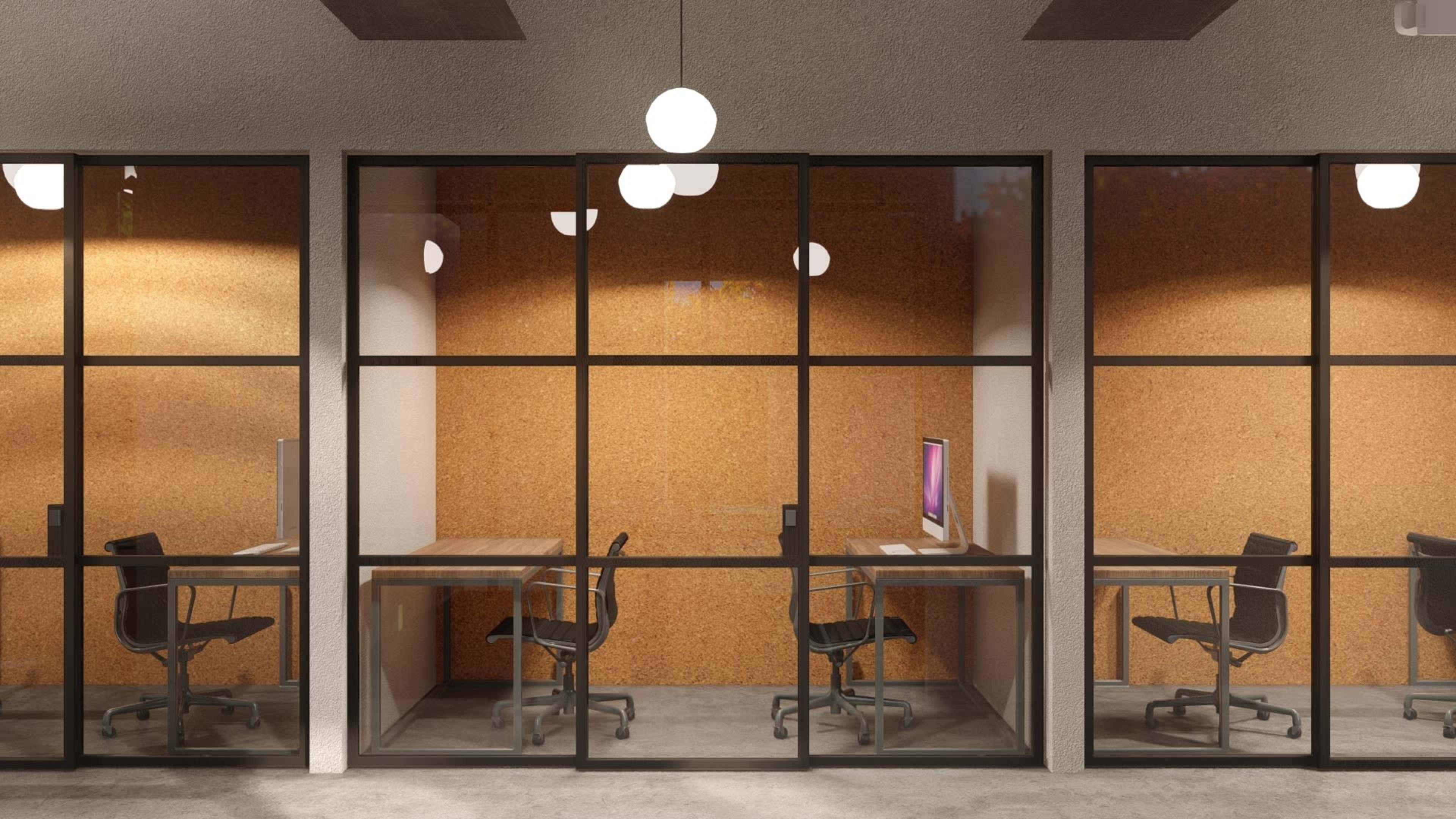 The image shows a modern office space with glass-walled rooms featuring cork walls, wooden desks, and ergonomic chairs.