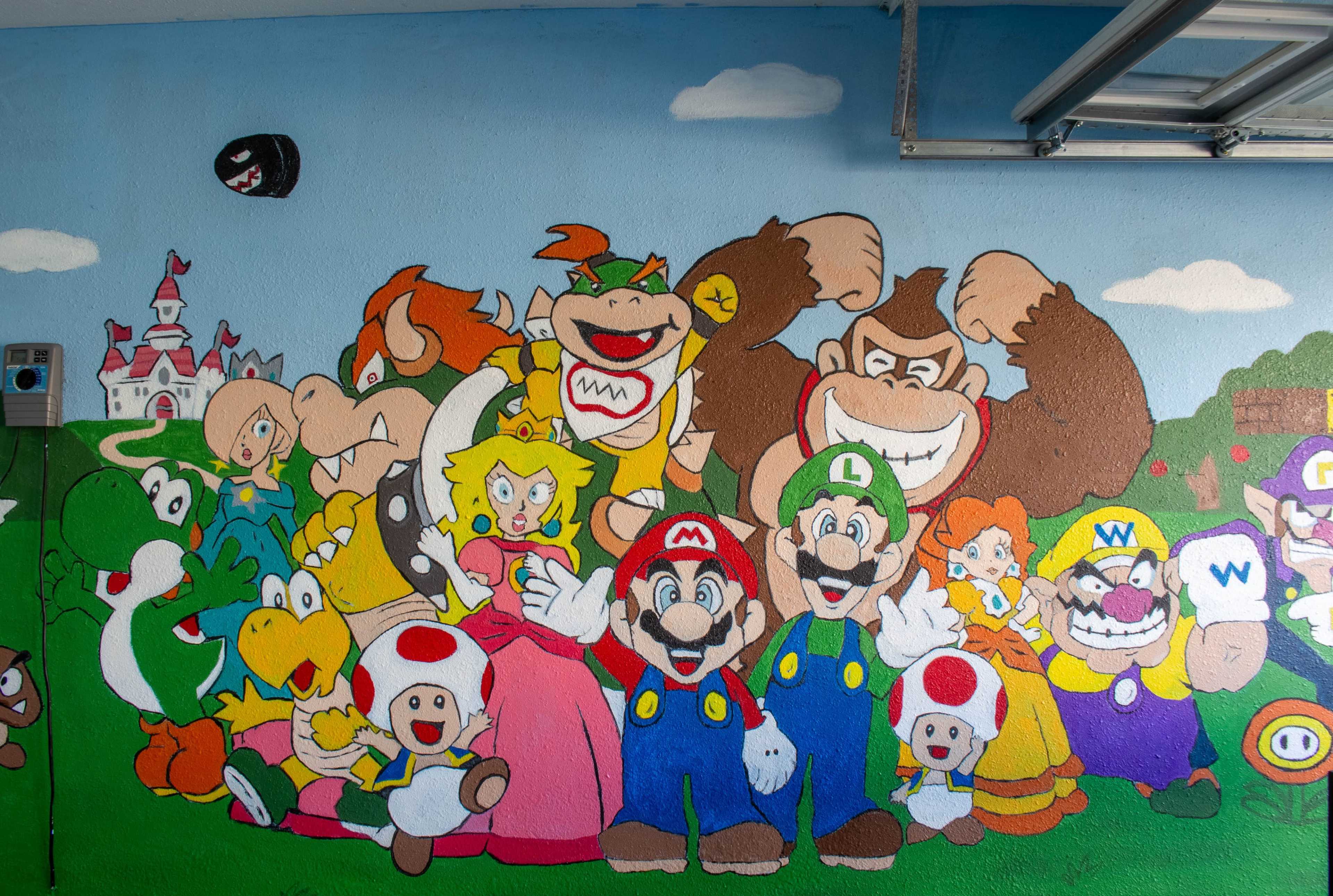 A vibrant mural depicting various characters from the Super Mario video game series, including Mario, Luigi, Princess Peach, and Bowser, among others.
