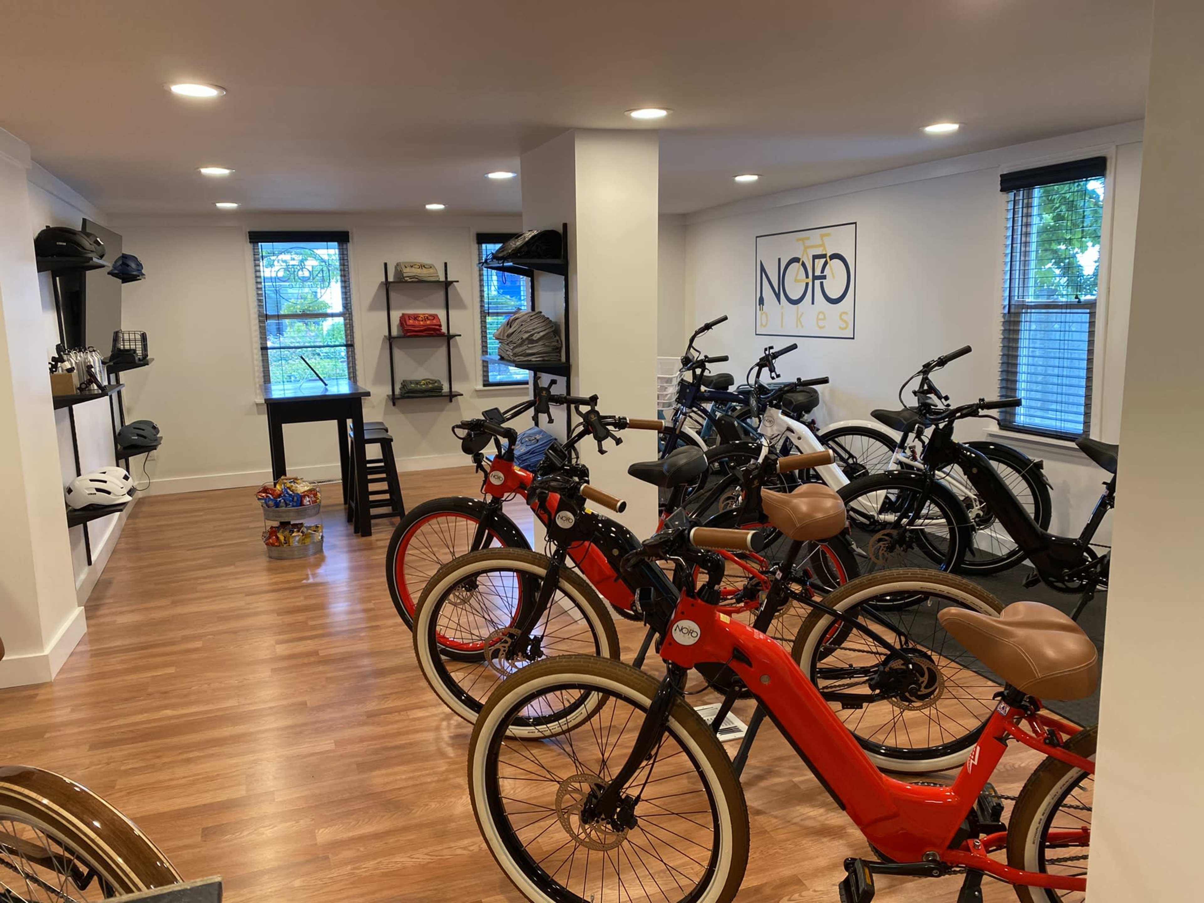 A bike shop interior featuring various bicycles and helmets displayed on shelves.