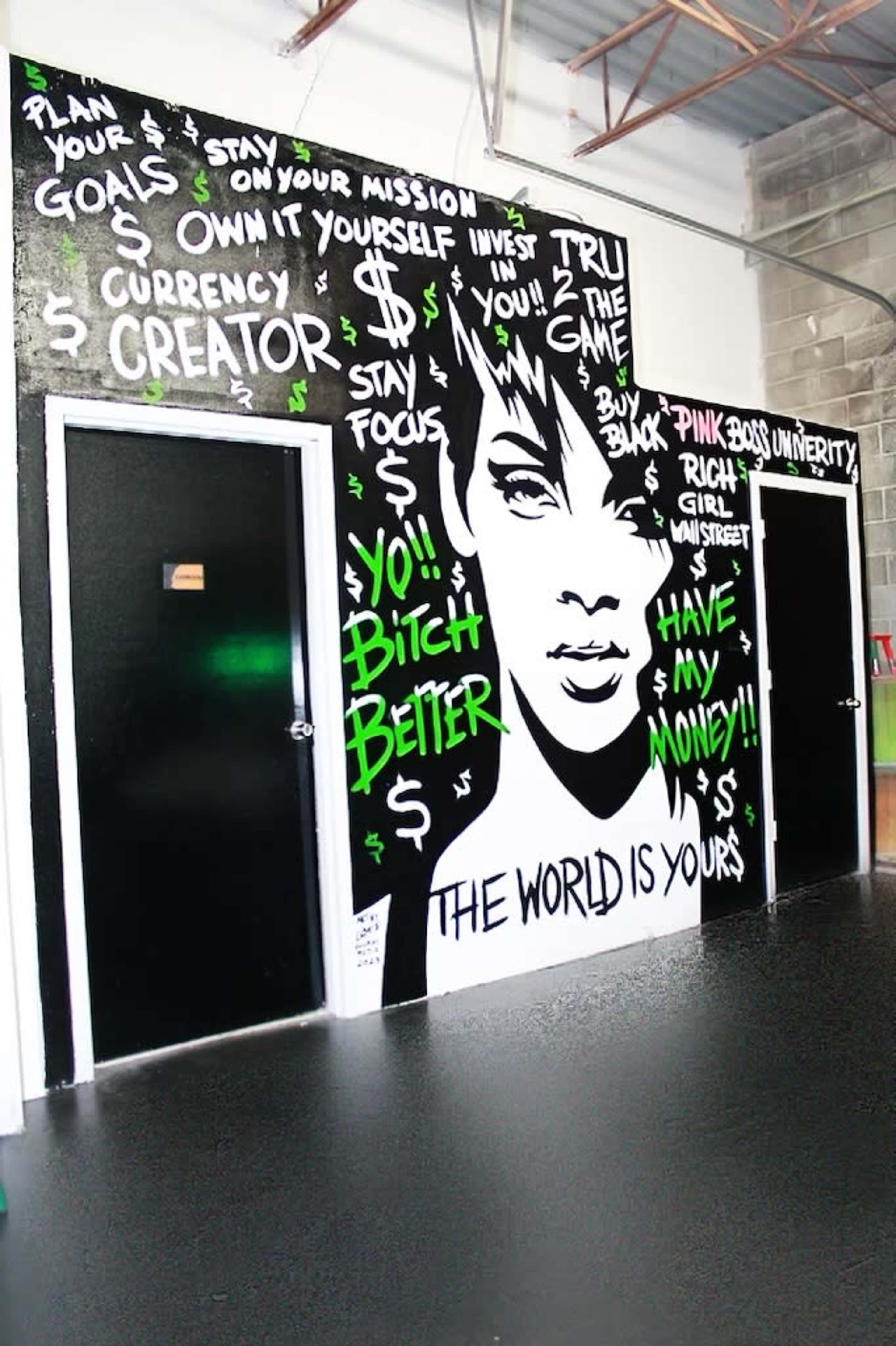 A black wall features a mural of a woman's face alongside motivational phrases and dollar signs.