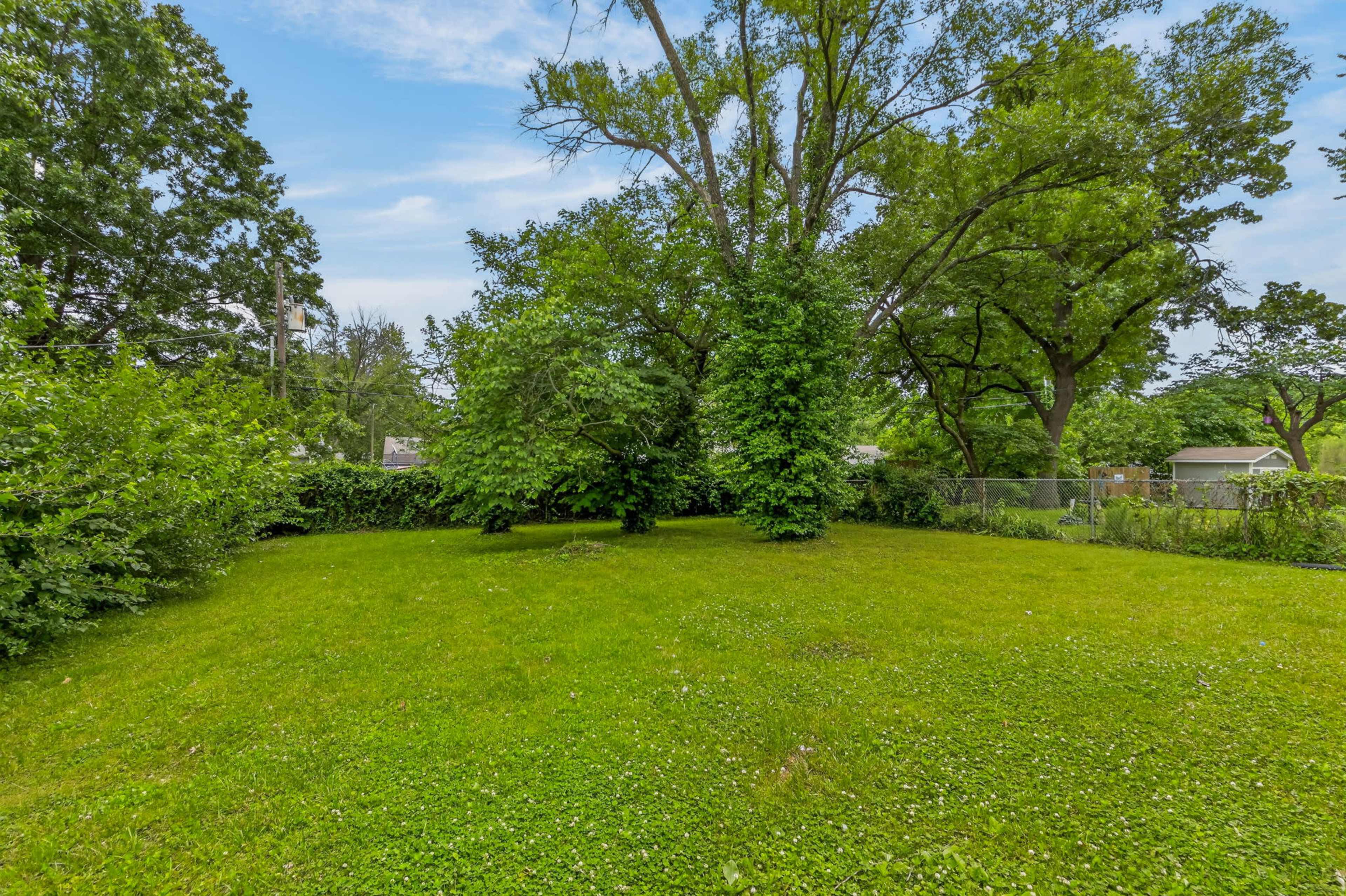 Moody Navy-Walled Bungalow with Bold Art & Backyard Image in Blue Township, Independence, MO