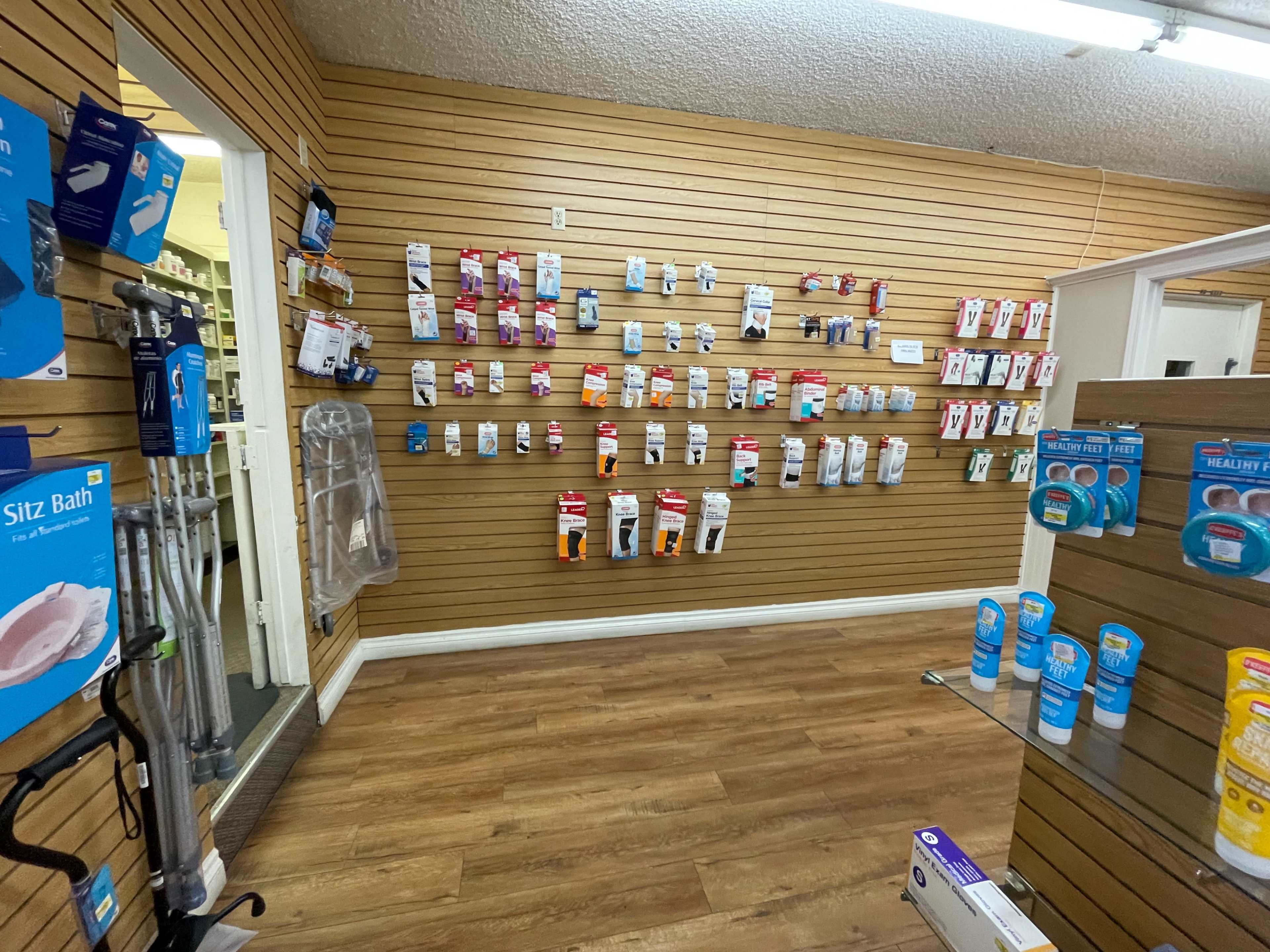 A retail display wall with various medical supplies and products organized on pegboards in a store.