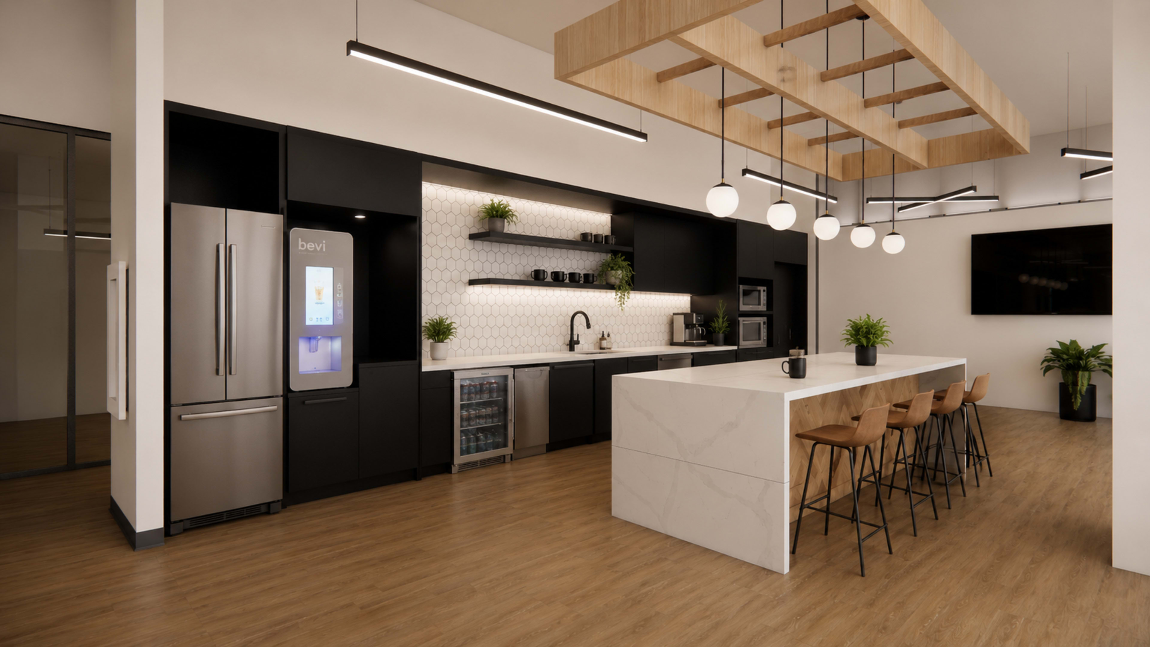 The image shows a modern kitchen area featuring a large island with bar stools, sleek cabinetry, and contemporary appliances.