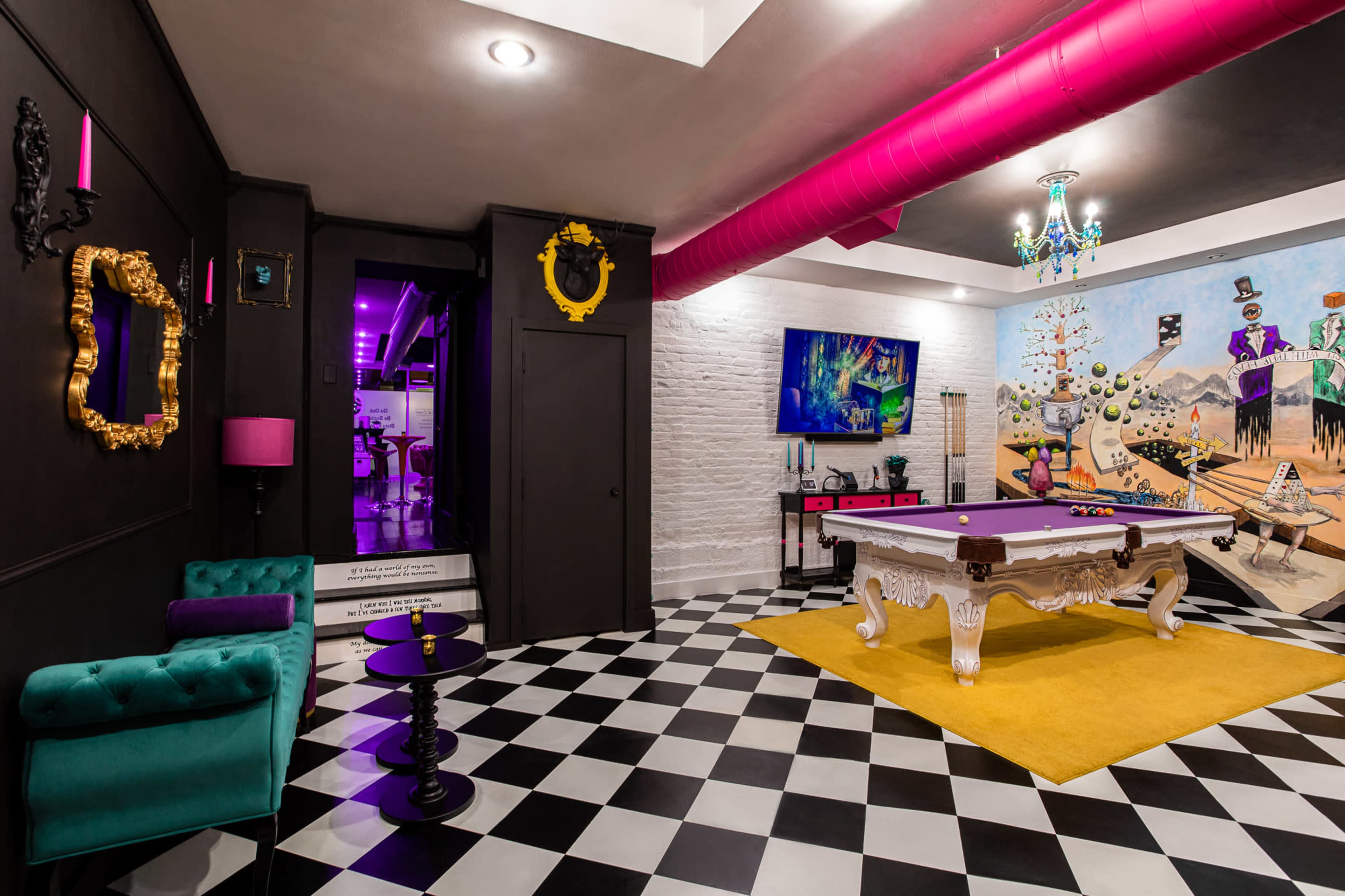 A vibrant game room featuring a pool table on a yellow rug, black and white checkered flooring, and bold purple and gold decor alongside a colorful mural on the wall.