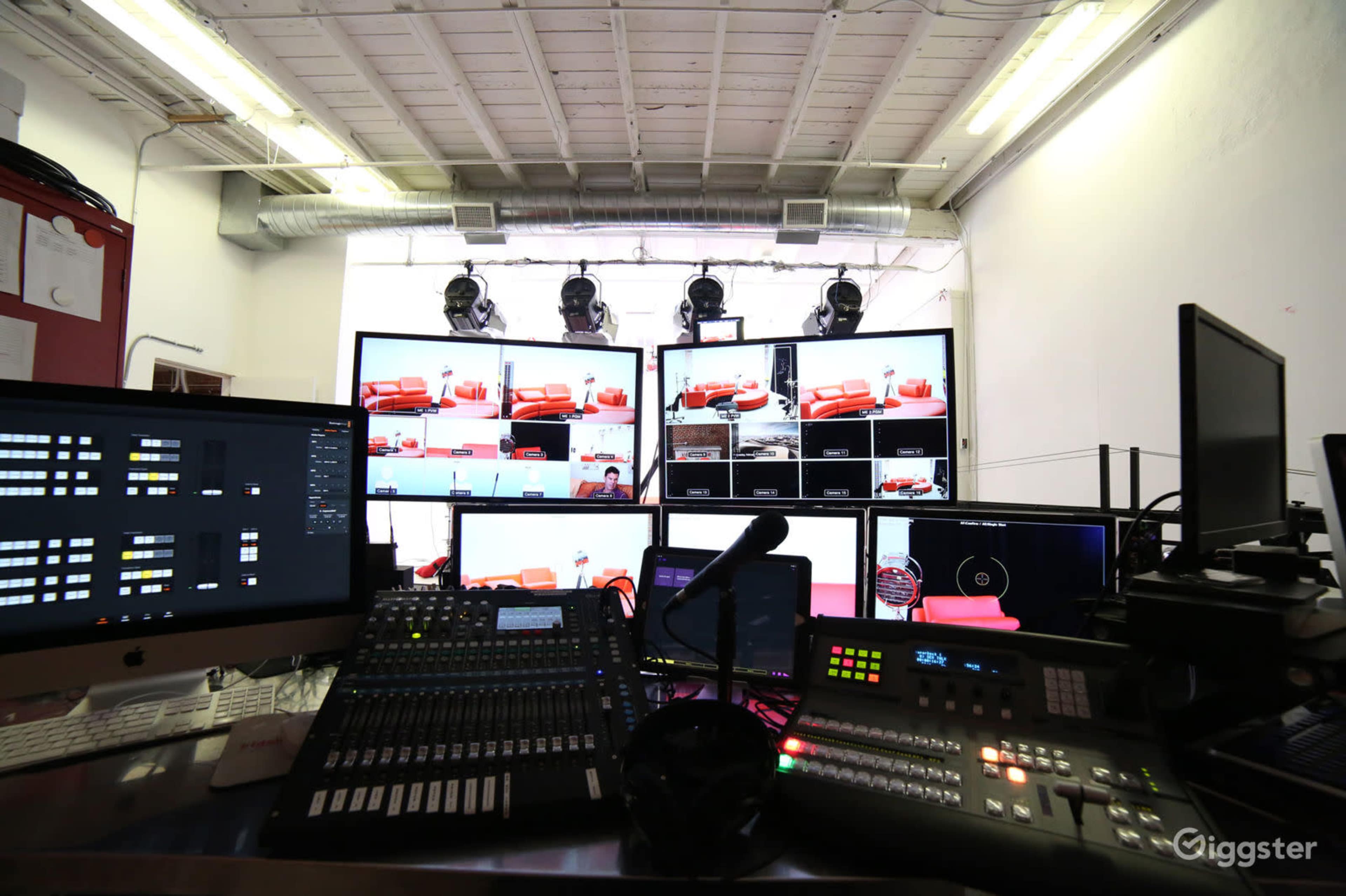 A video production control room equipped with multiple screens displaying images and various audio-visual equipment.