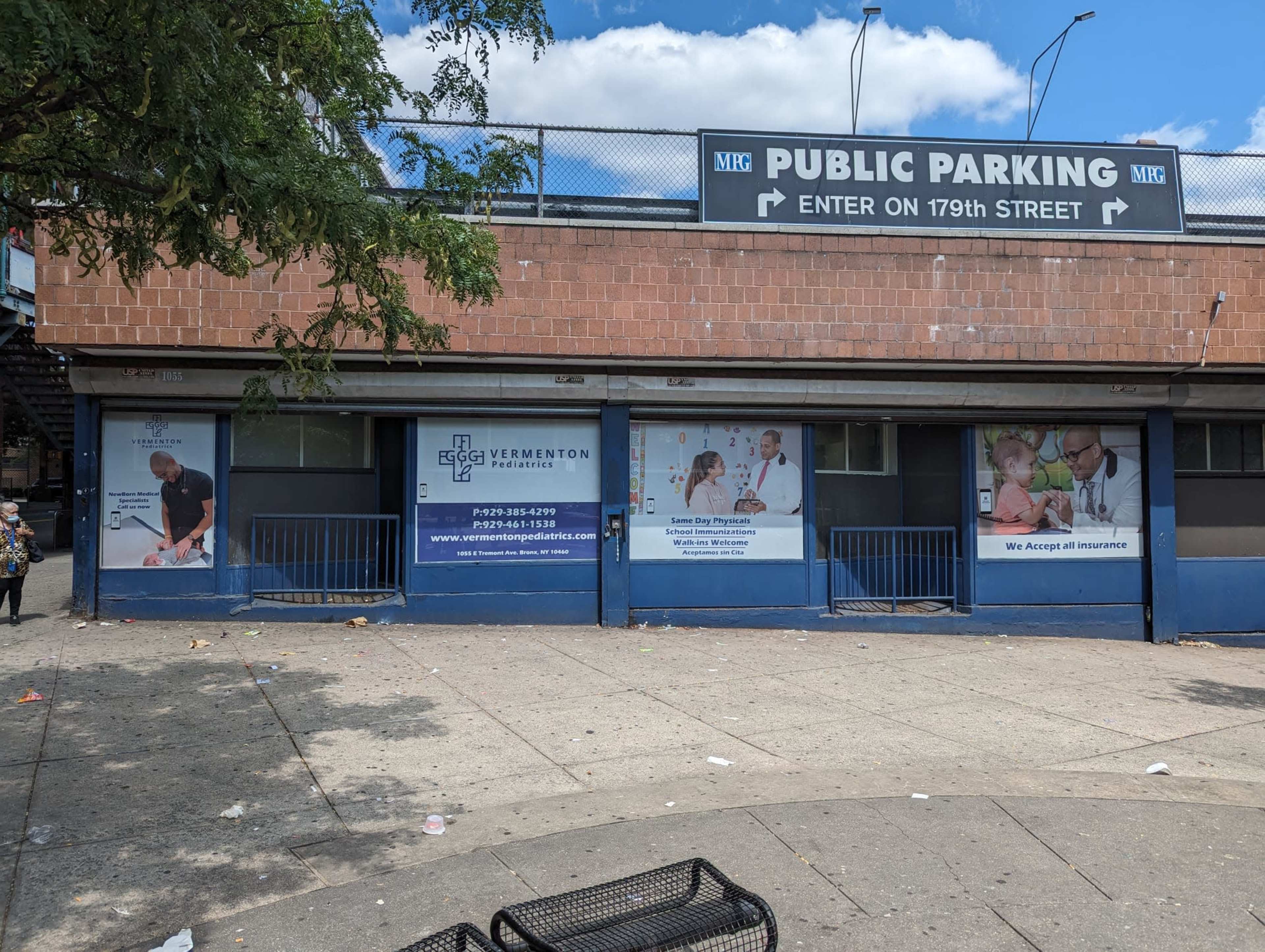 A brick building with advertisements for Vermont Healthcare and a public parking sign above it, located on 19th Street.