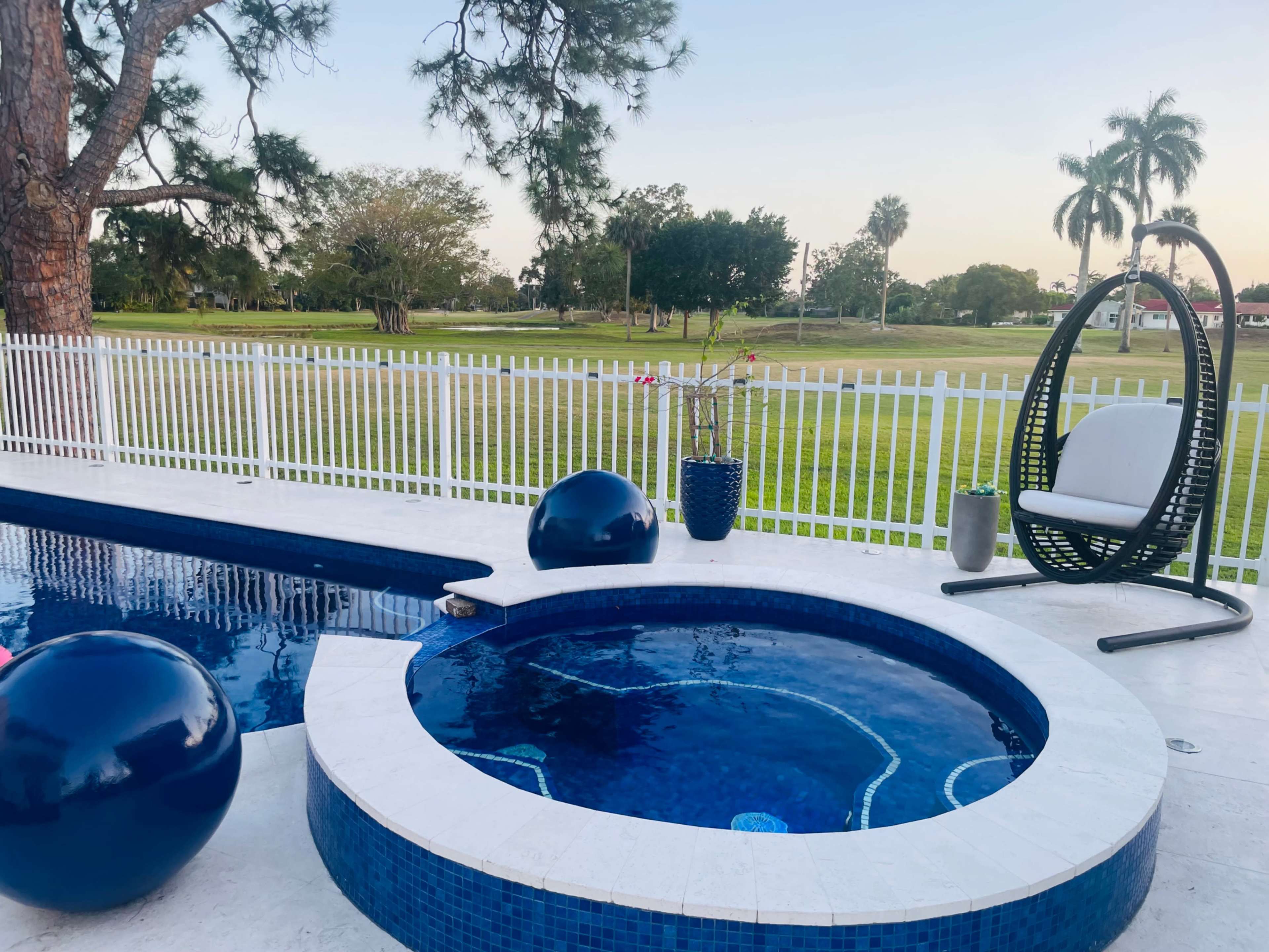 Country club, suburban, outdoor area with pool. Golf course view, roomy area with plenty of seating. Image in Country Club, Miami, FL