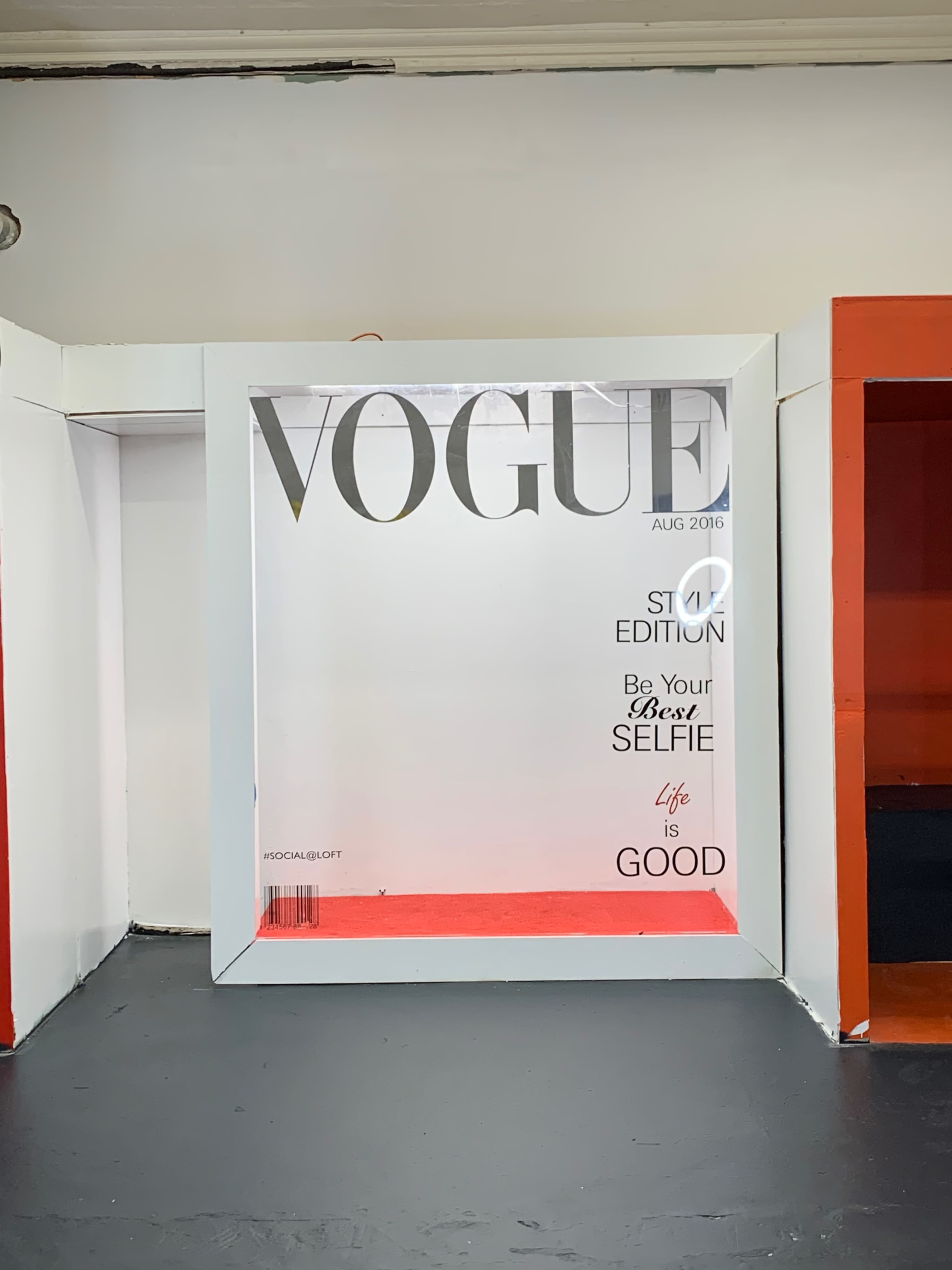 A large frame designed to resemble a Vogue magazine cover, with text promoting a selfie edition.
