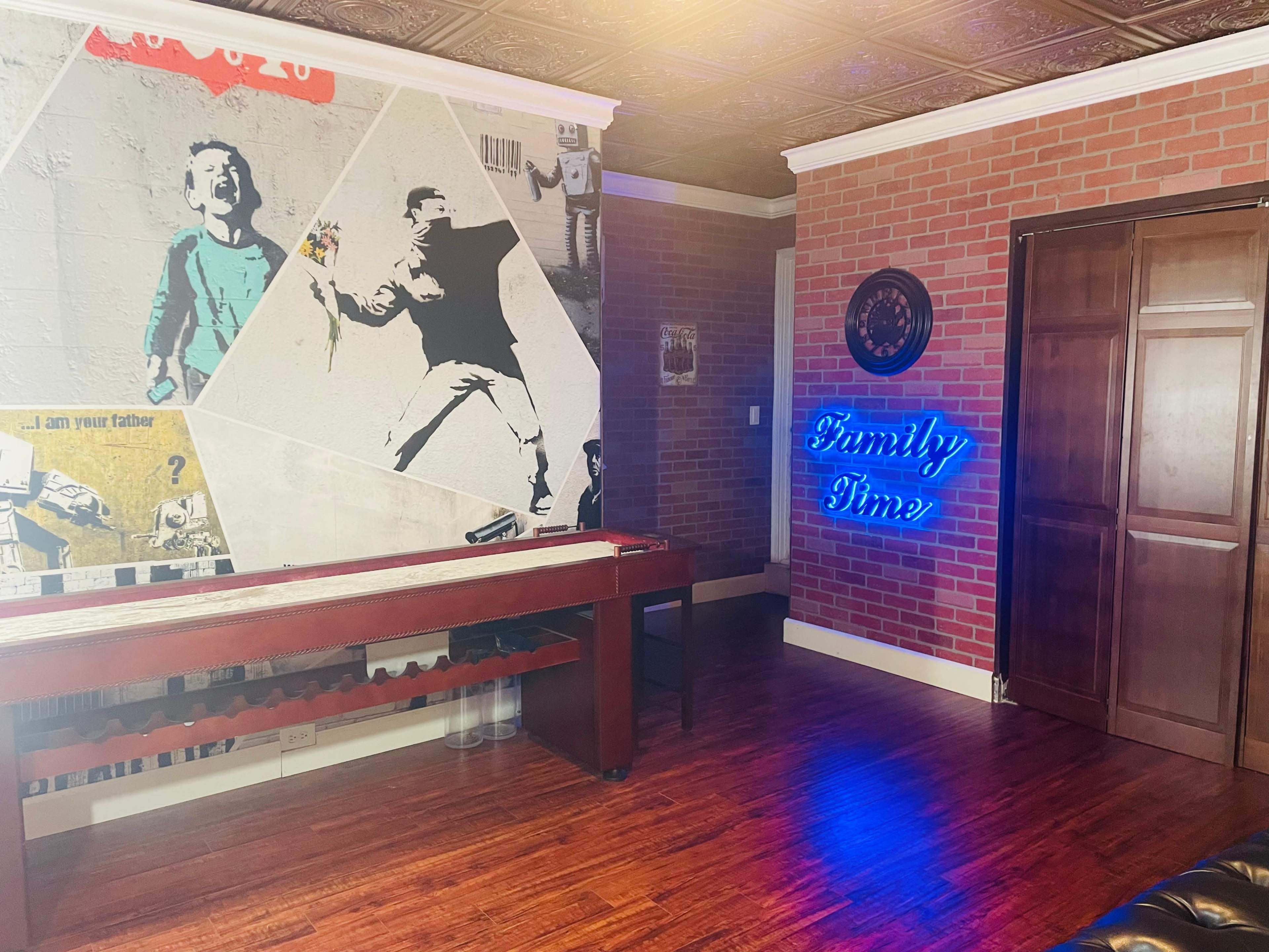 The image shows a room with brick-patterned walls, a wooden floor, and a neon sign that reads "Family Time."