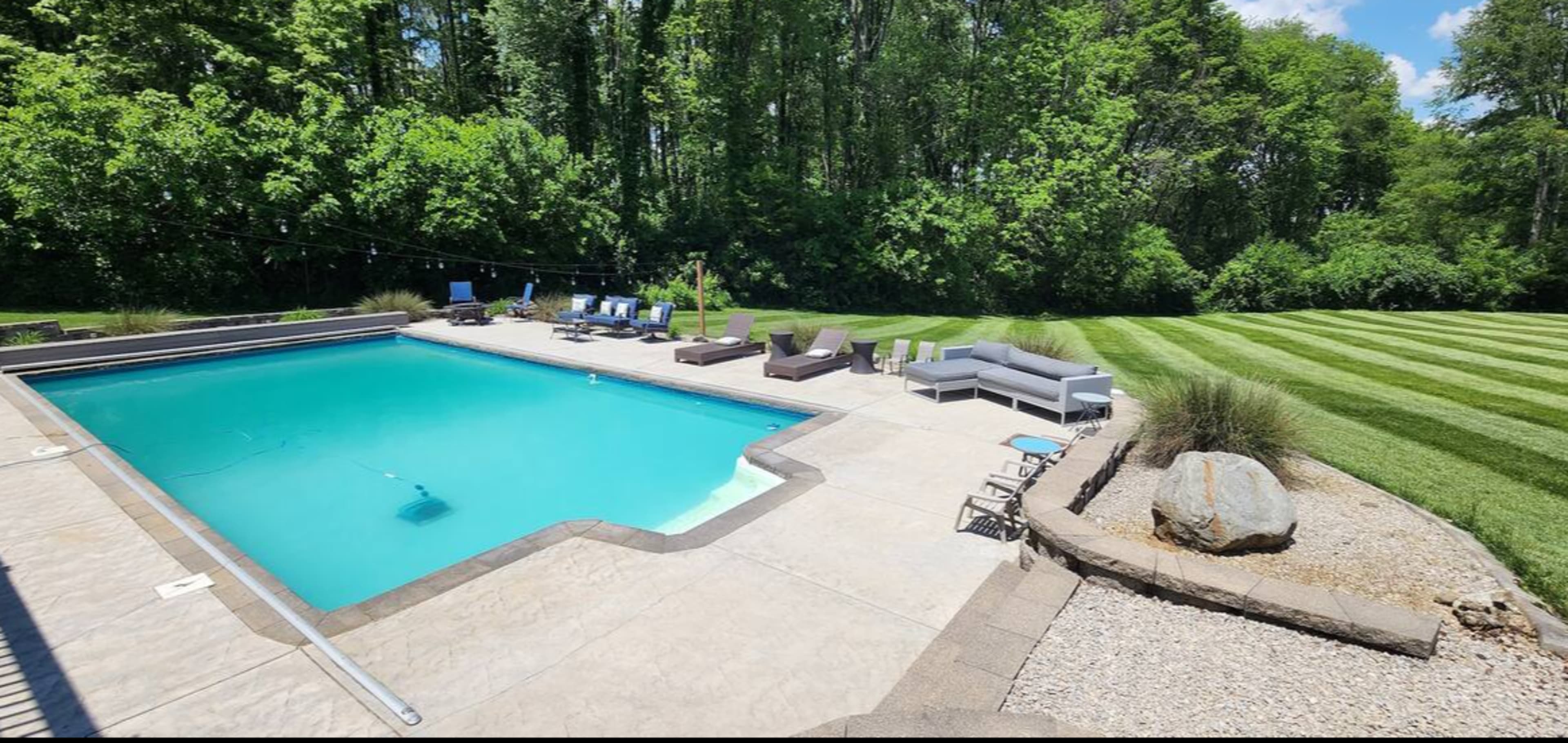 Beautiful farmhouse setting with huge inground pool with walkout basement. Image in Clark Township, Greenwood, IN