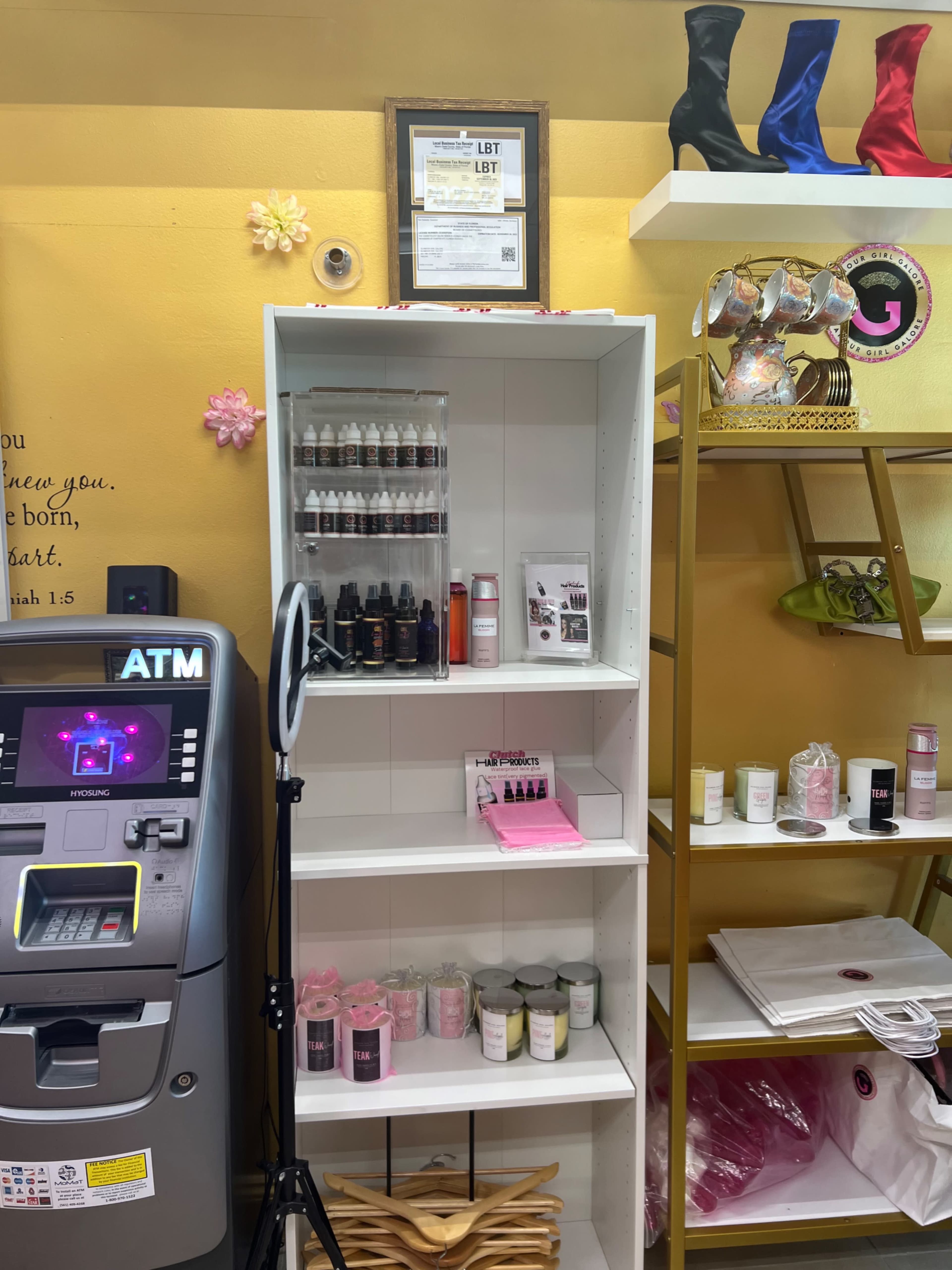 The image shows a cosmetics display shelf stocked with various beauty products next to an ATM and a rack of shoes in a shop.
