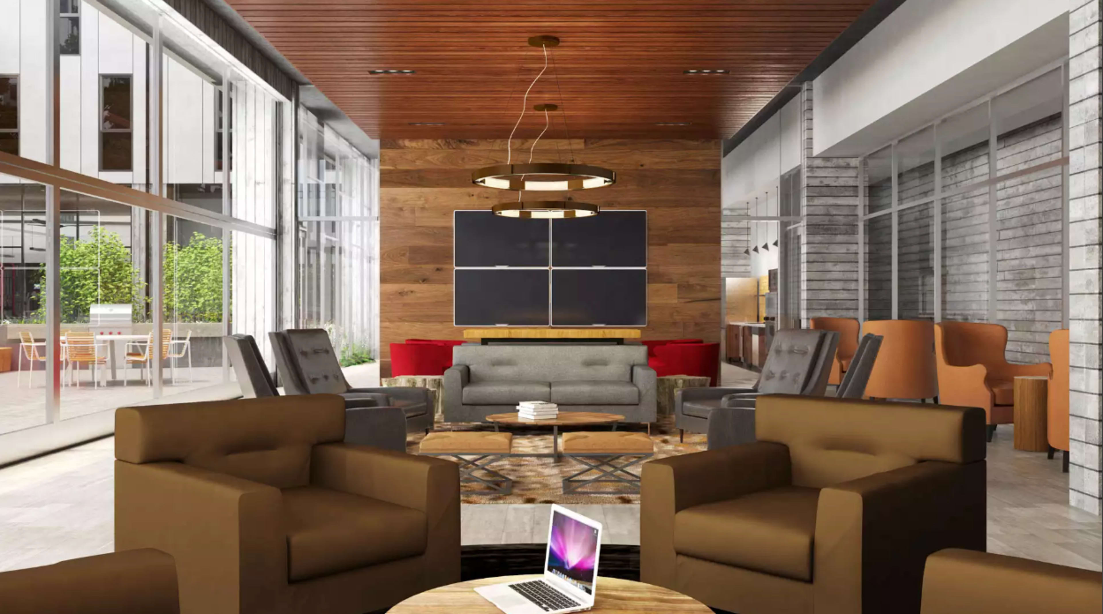 A modern lounge area with a mix of seating arrangements, wooden accents, and large windows letting in natural light.
