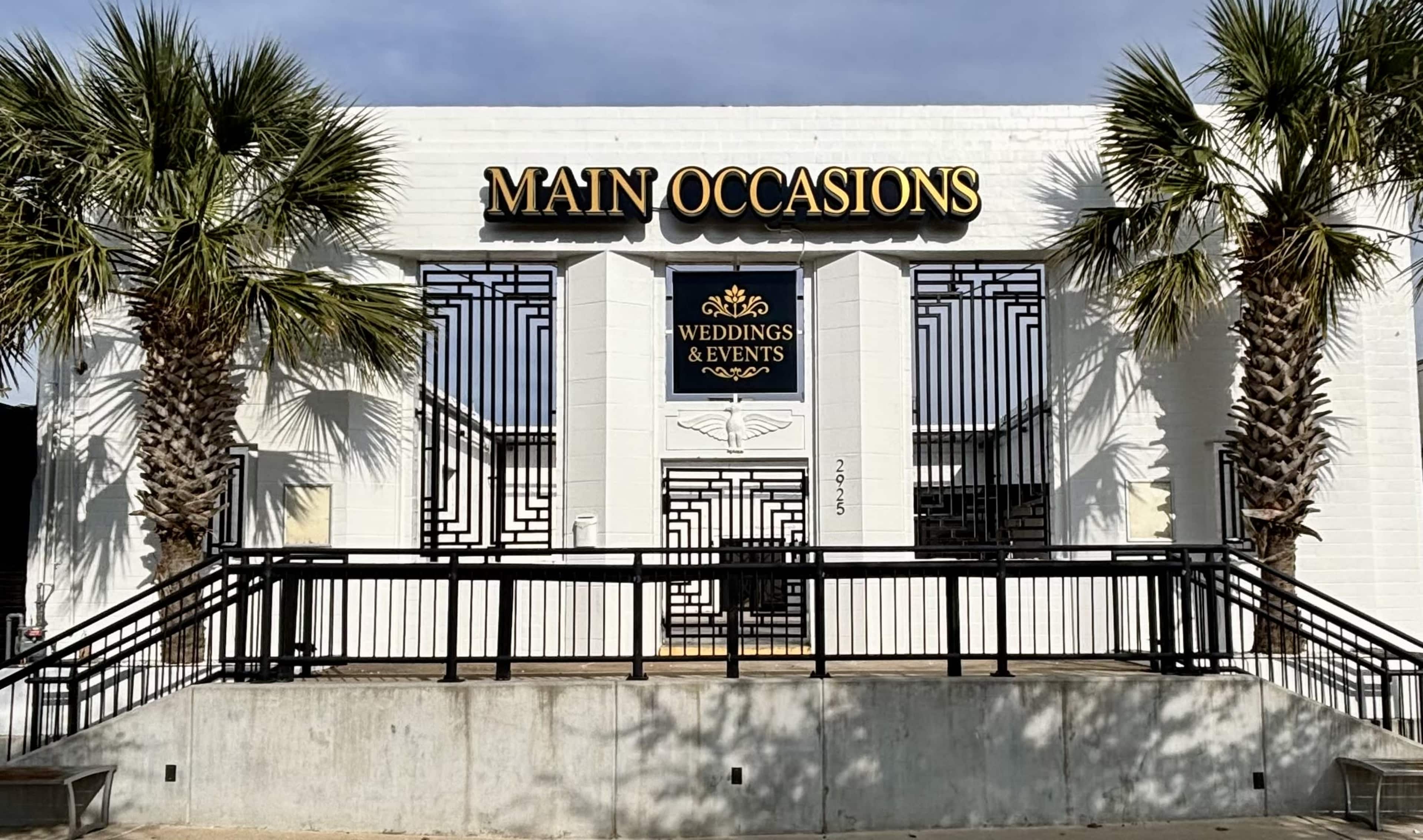 The building features a white exterior with a large sign that reads "MAIN OCCASIONS" above a decorative entrance labeled "WEDDINGS & EVENTS."