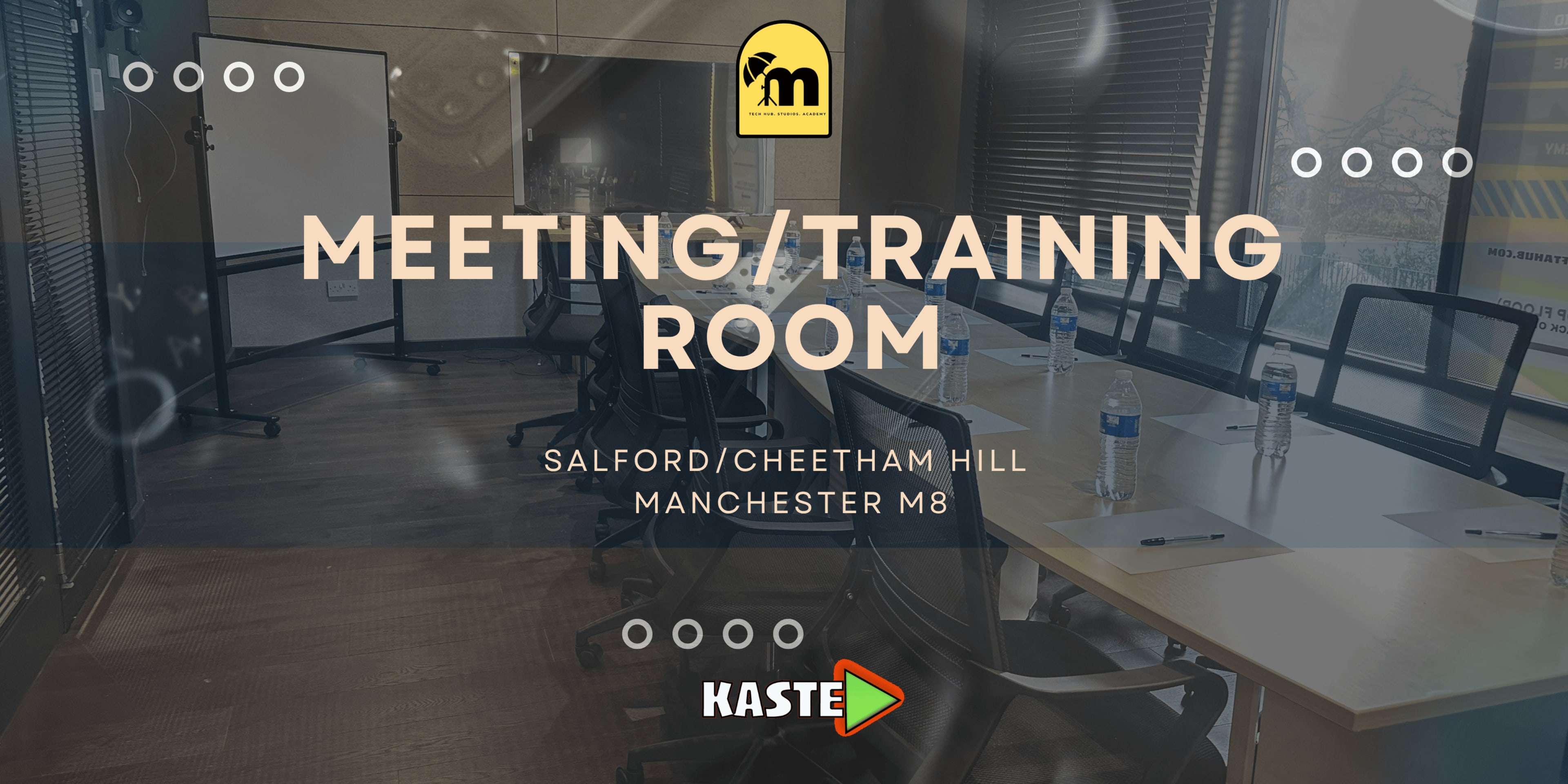 The image shows a meeting or training room set up with a large table, chairs, and a projector screen in the background.