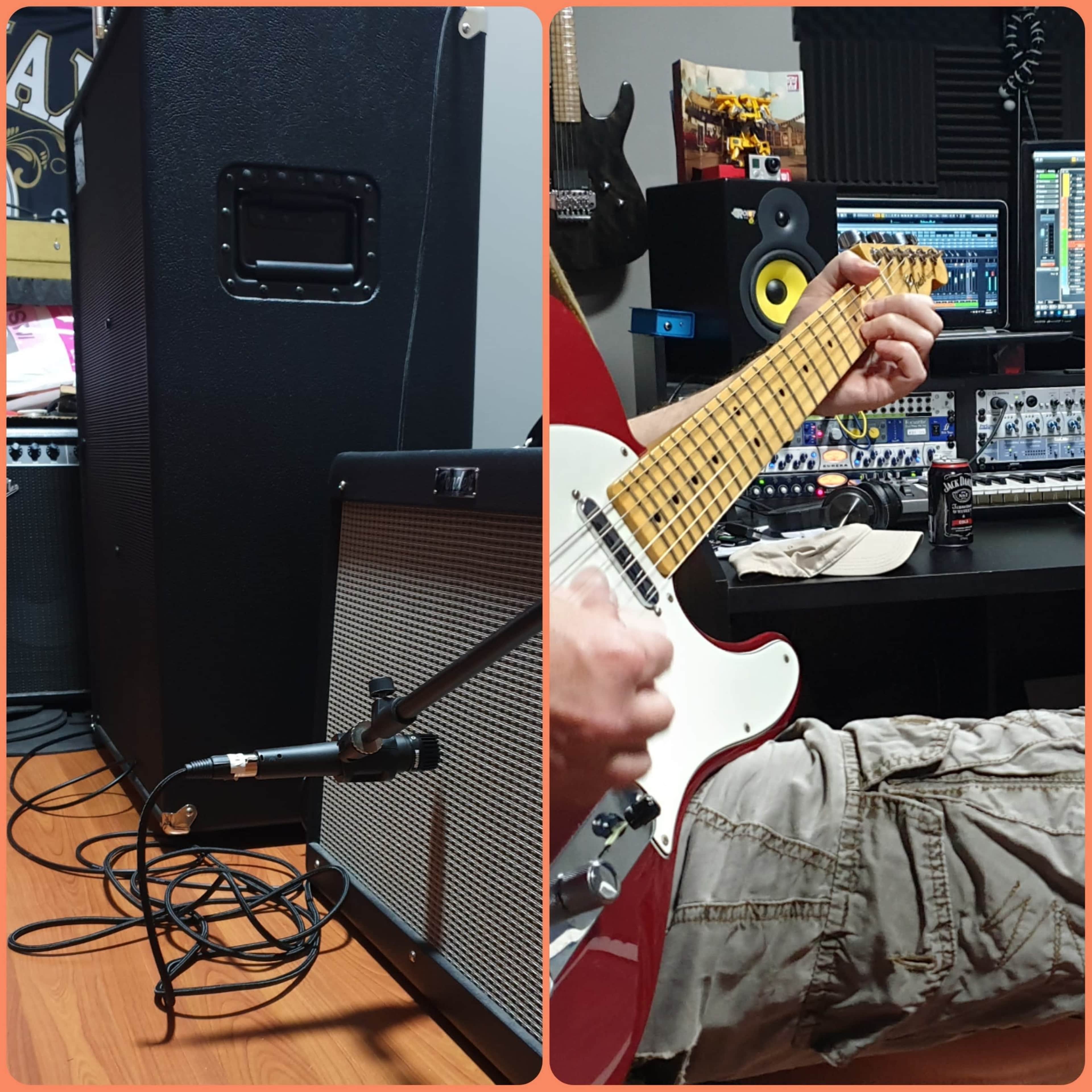 A person playing a white electric guitar while seated next to an audio mixing setup and a large amplifier.