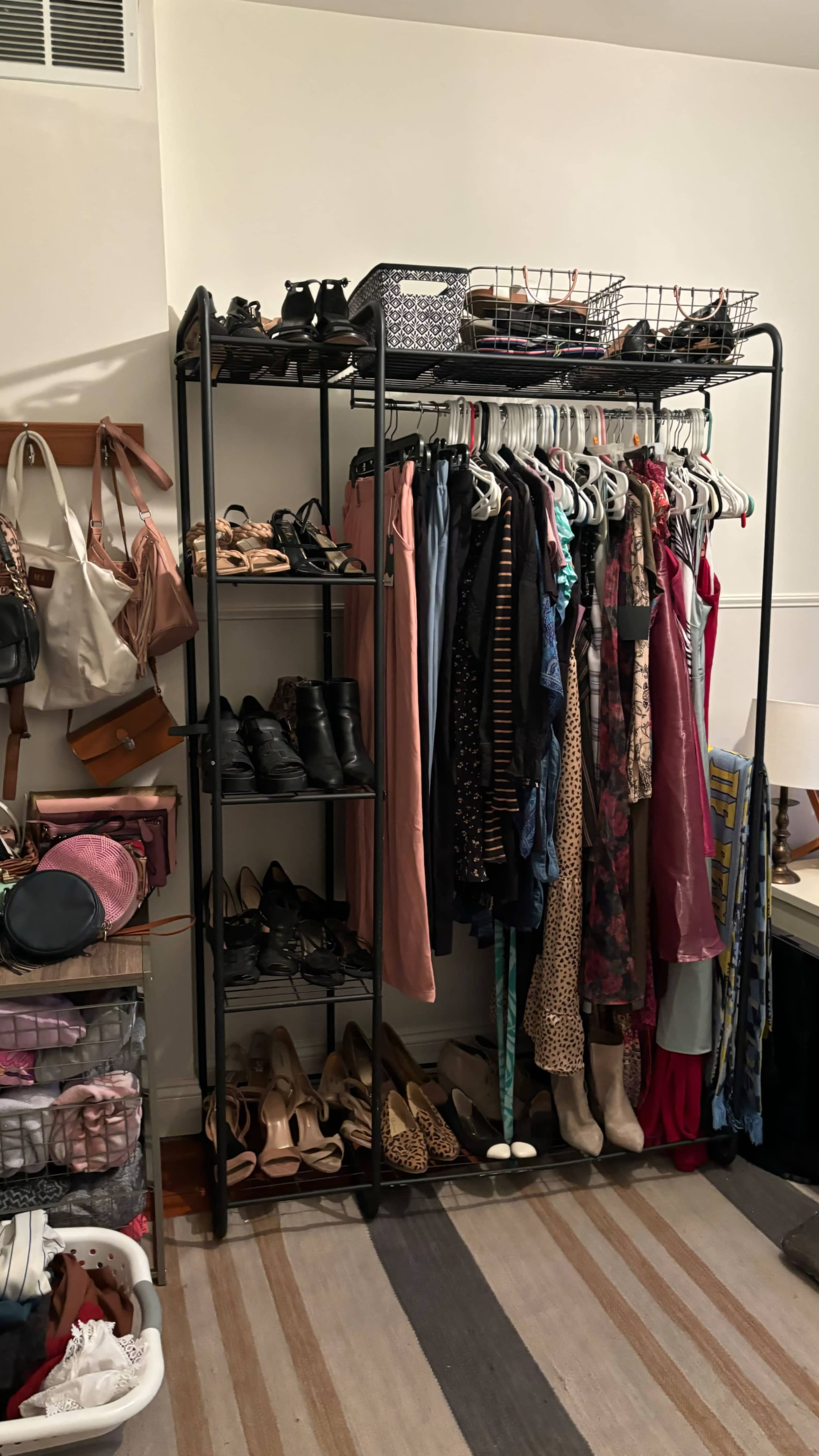 The image shows a clothing rack filled with various dresses and garments, paired with shelves underneath displaying shoes and bags in a closet setting.