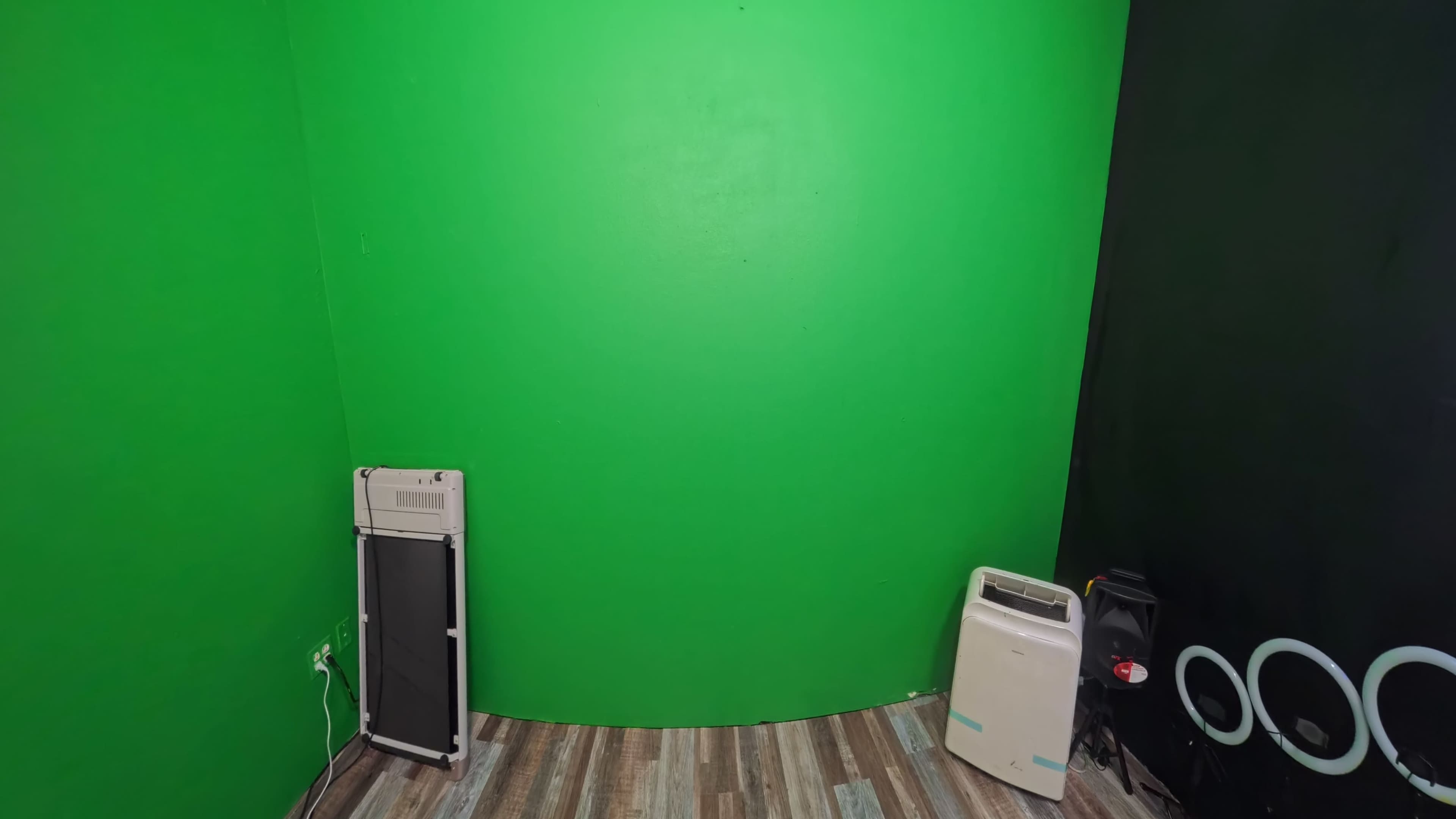 The image shows a room with a bright green wall and two appliances, one on the left and one on the right.