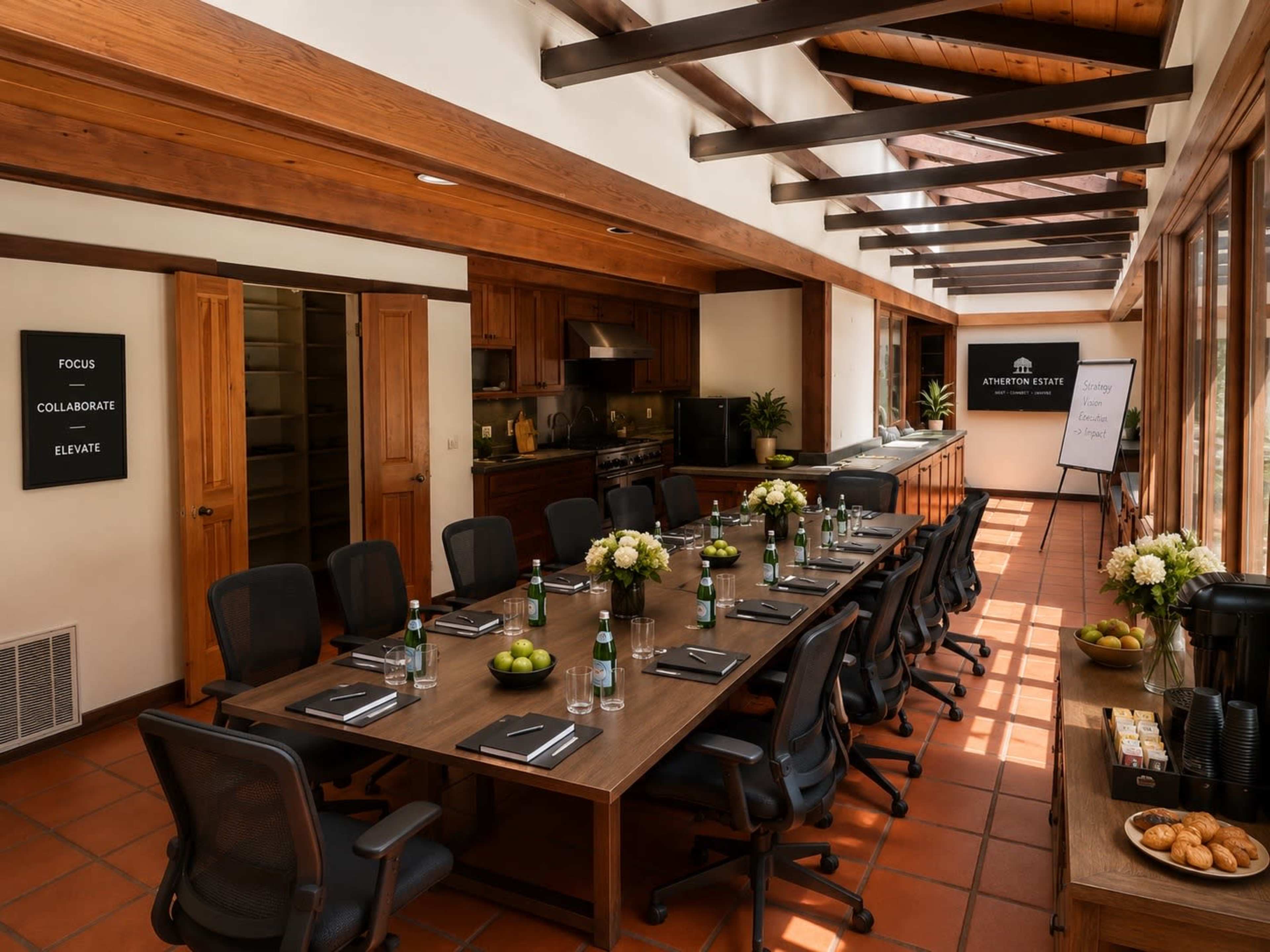 The image shows a modern conference room with a long wooden table set for a meeting, surrounded by chairs, and featuring large windows that allow natural light.