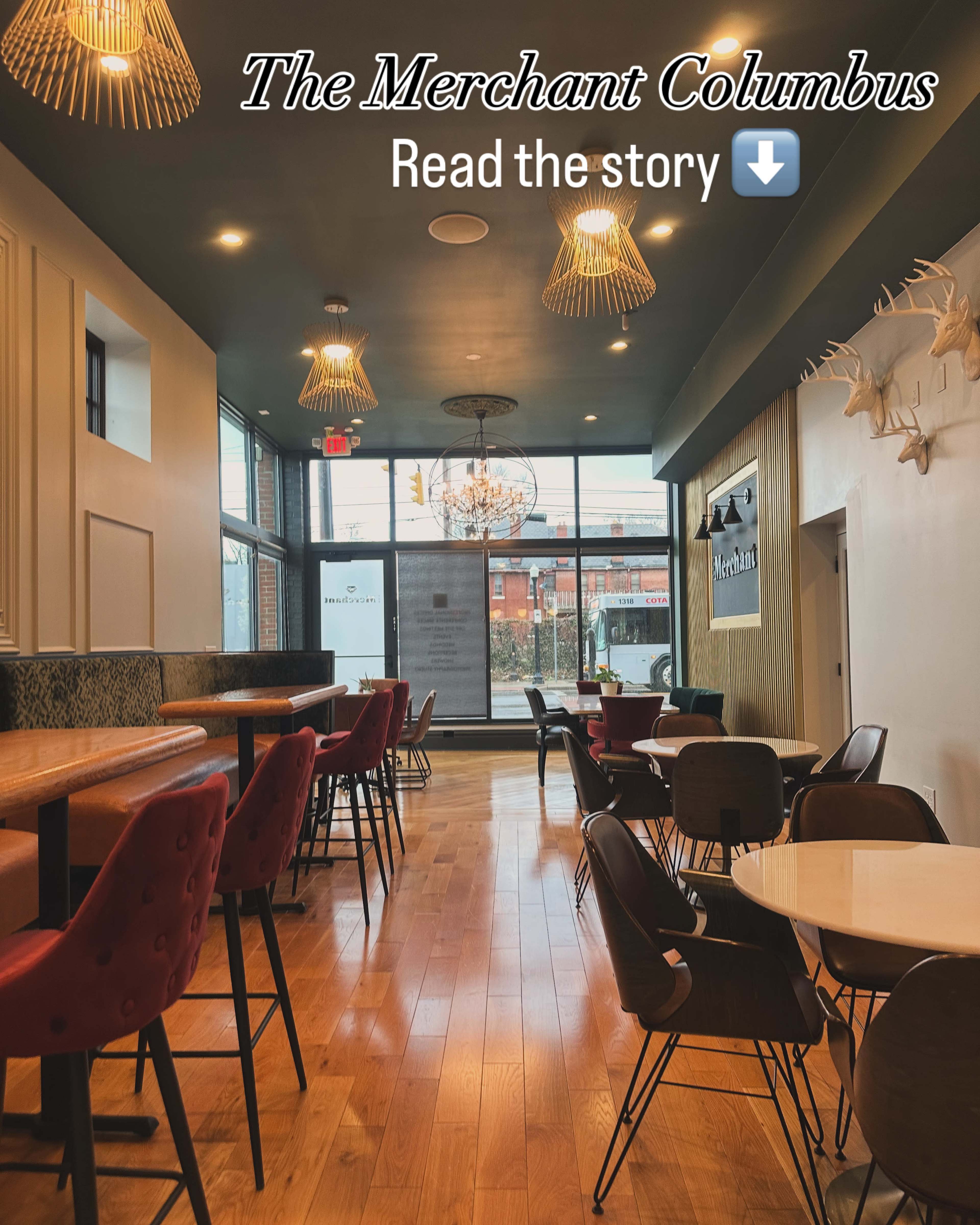 The image shows a modern café interior with wooden floors, tables, and chairs, featuring large windows that allow natural light to enter the space.