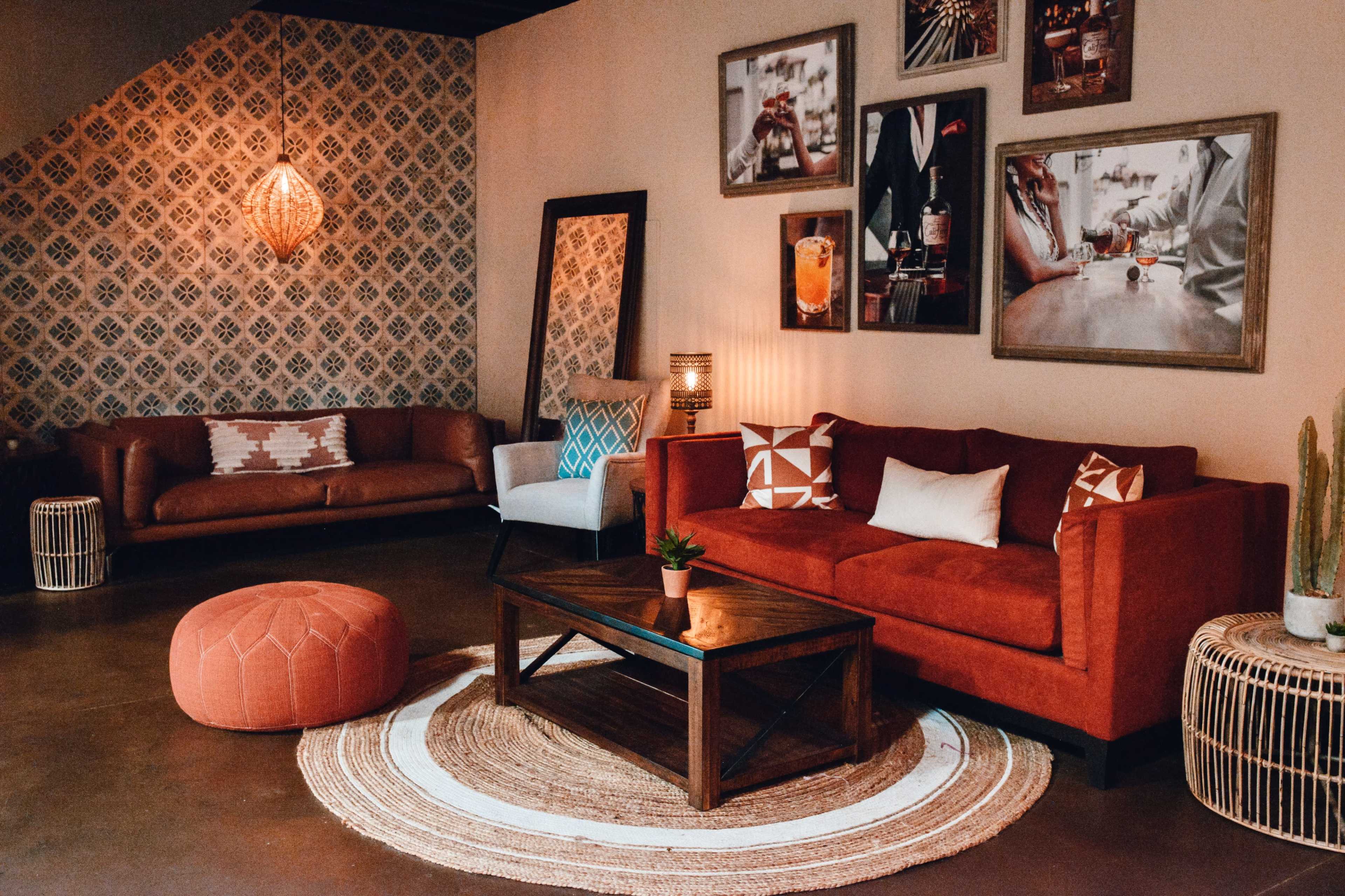 A contemporary living space featuring two sofas, a coffee table, and decorative wall art, all set against a patterned backdrop.