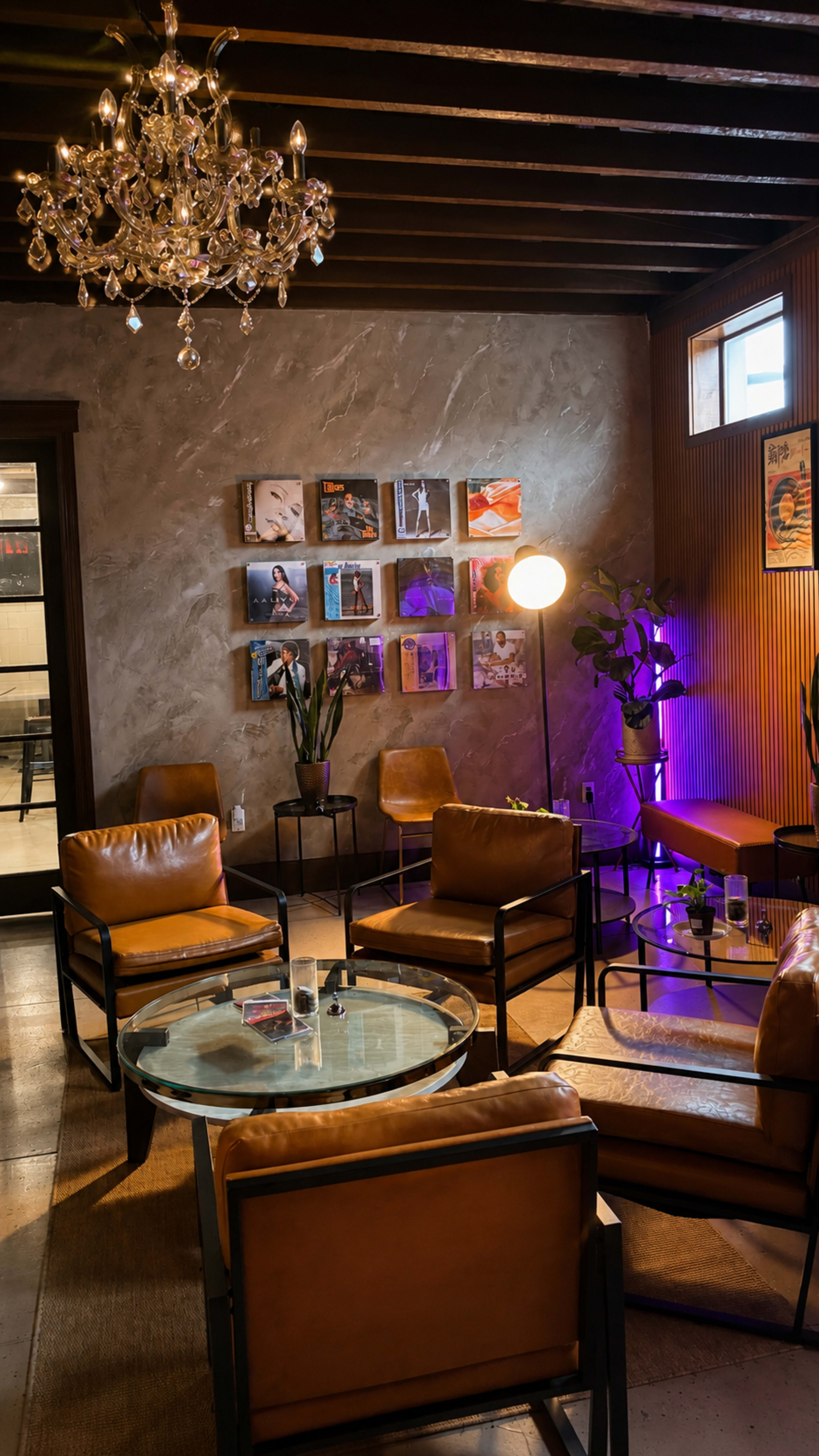 The scene features a cozy lounge area with leather armchairs, a glass coffee table, and a chandelier, accompanied by framed artwork on the walls and a potted plant.