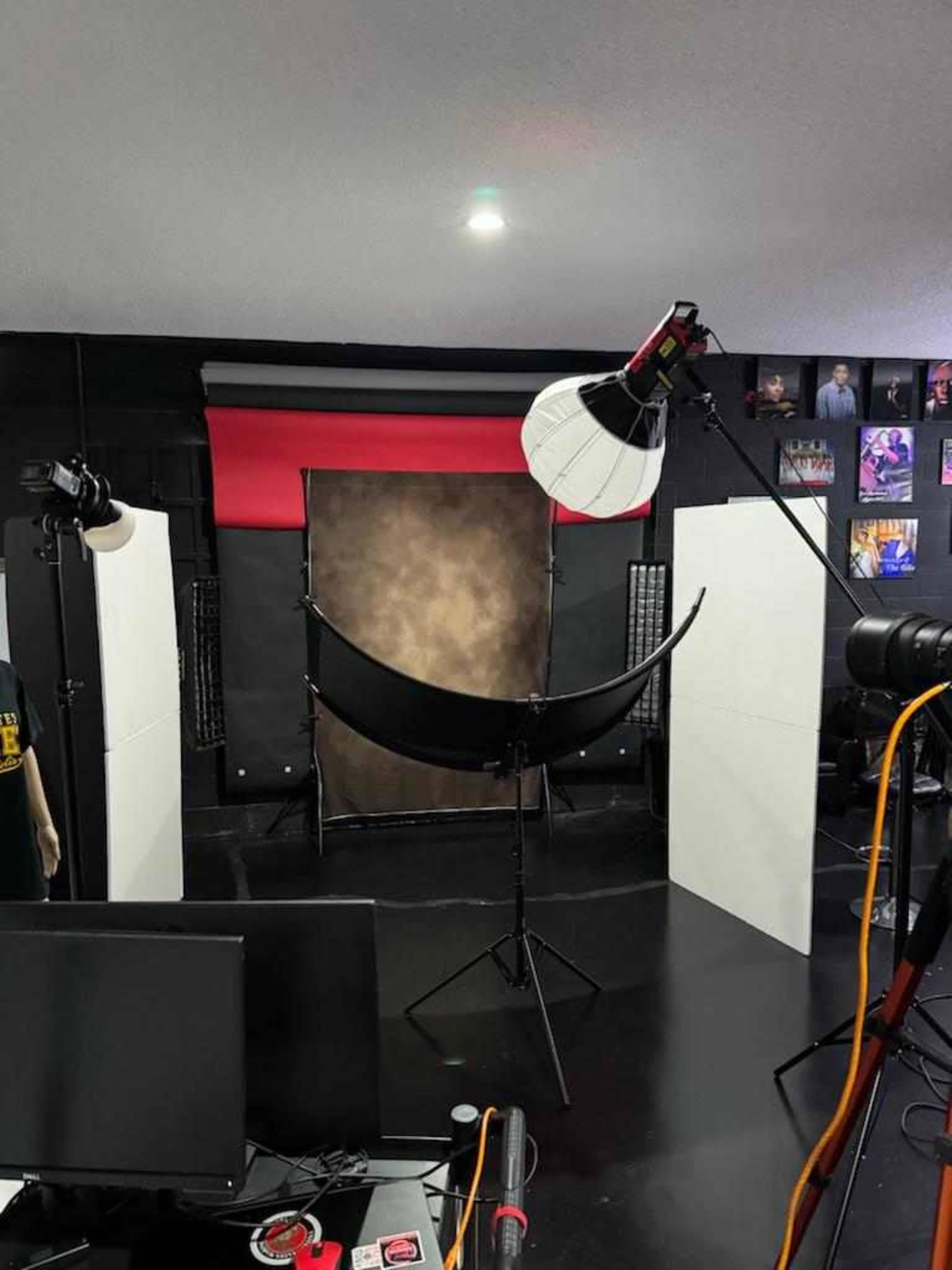A photography studio setup with lights, backdrops, and equipment arranged for a shooting session.