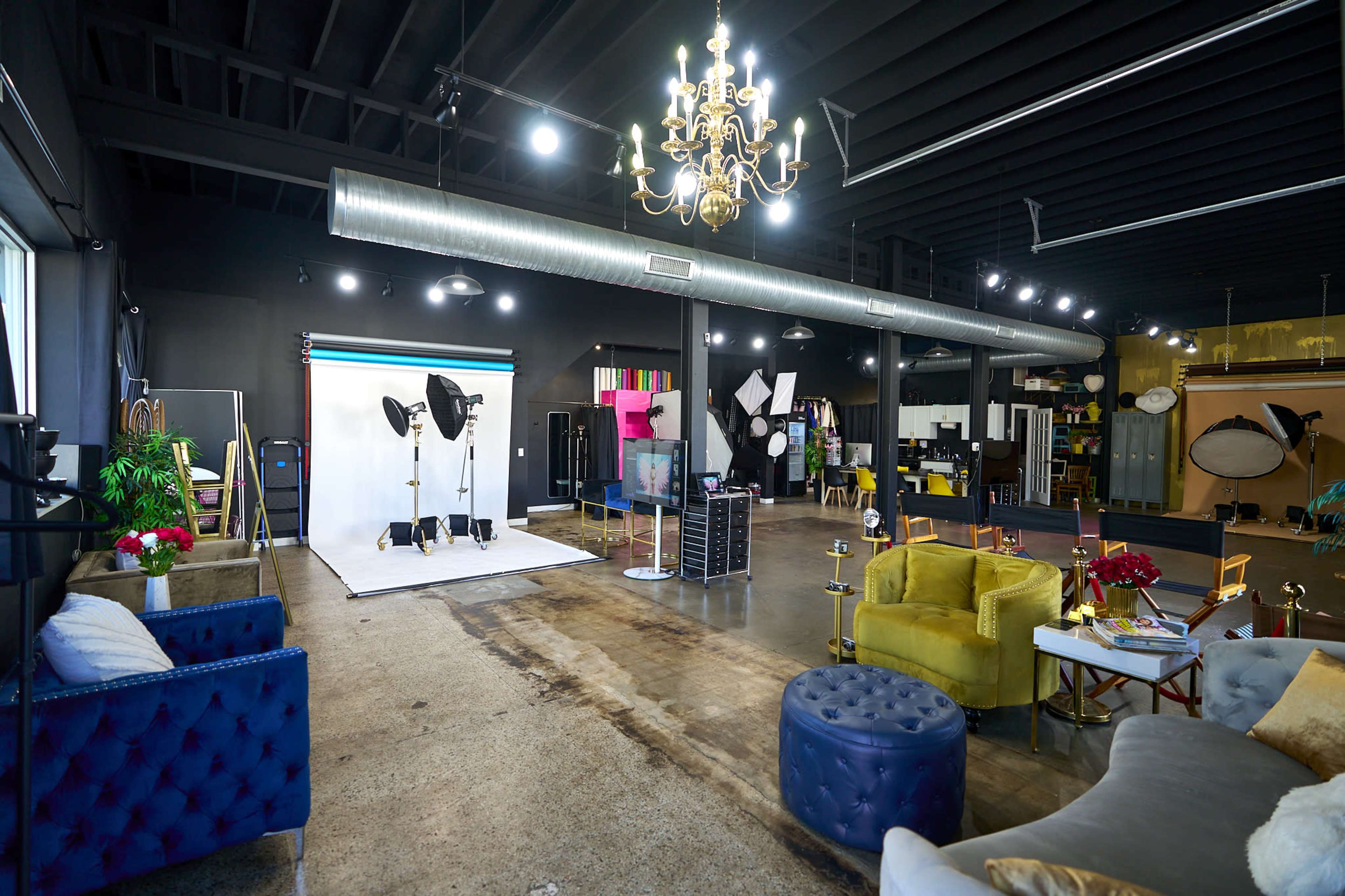A large studio space with various photography equipment, seating areas, and decorative elements.