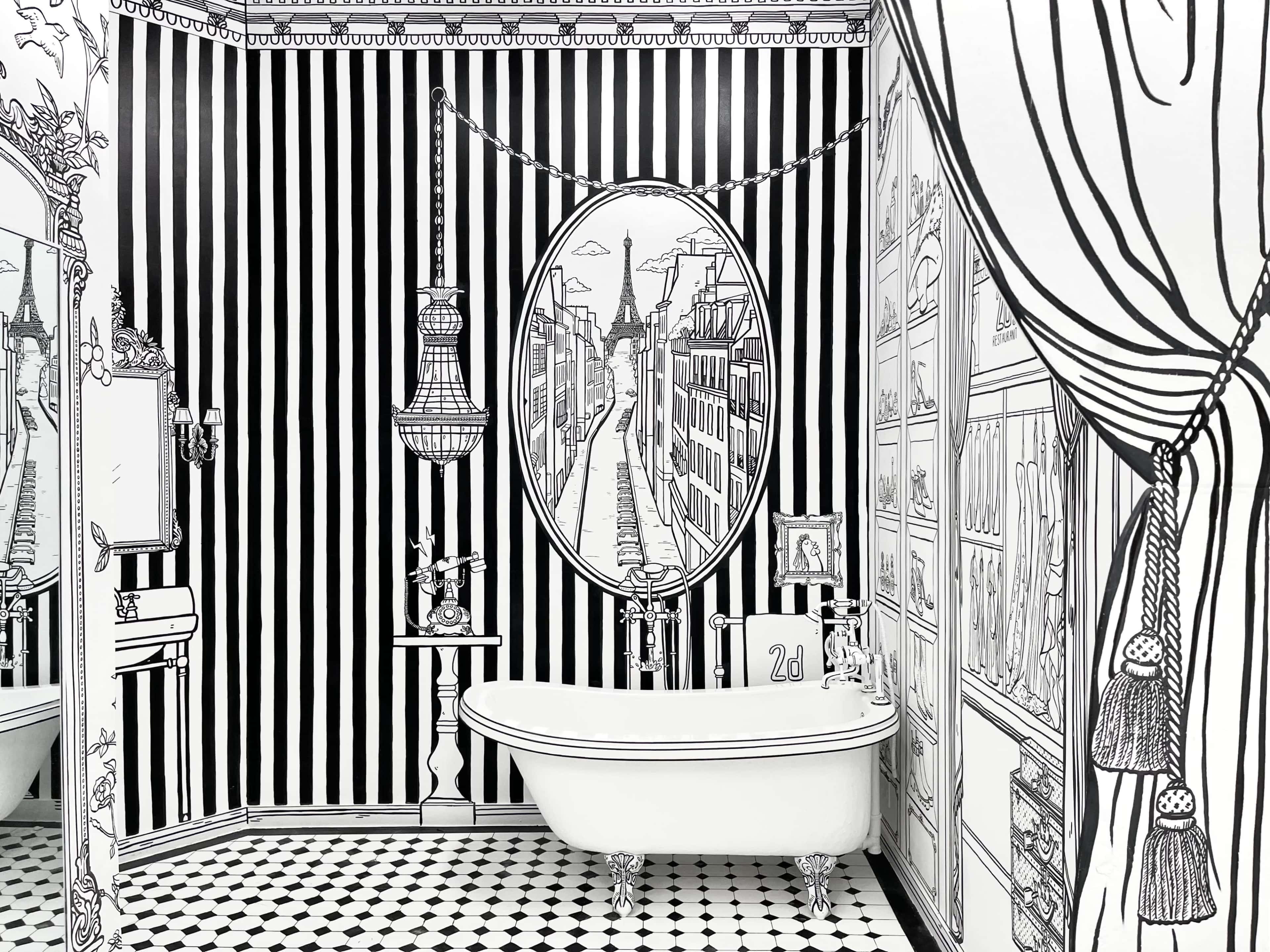 A bathroom features black and white striped walls with an illustrated mirror reflecting a street view, and a vintage bathtub in the center.