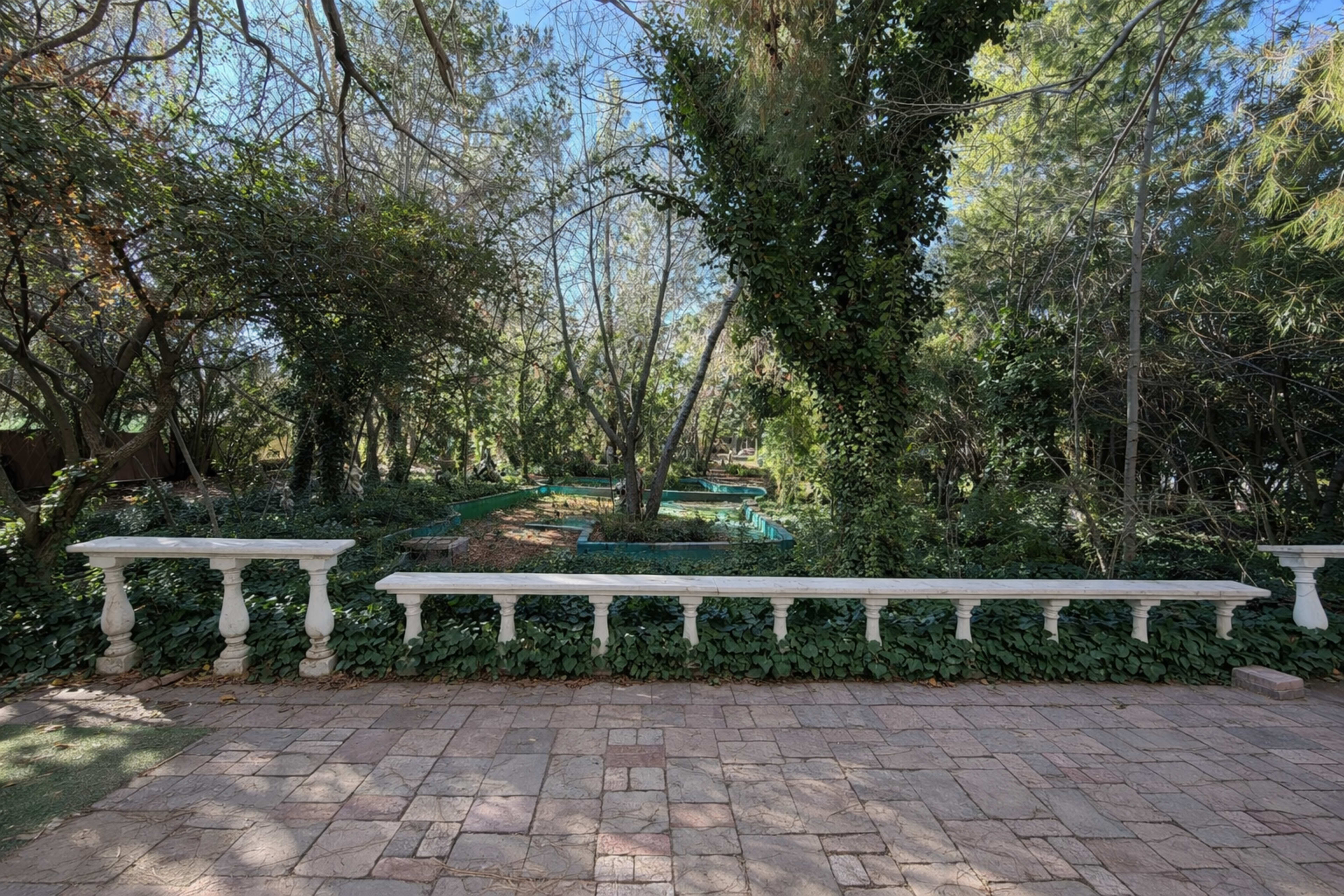 European-Style Garden Courtyard with Lush Greenery Image in Sun Village, Littlerock, CA
