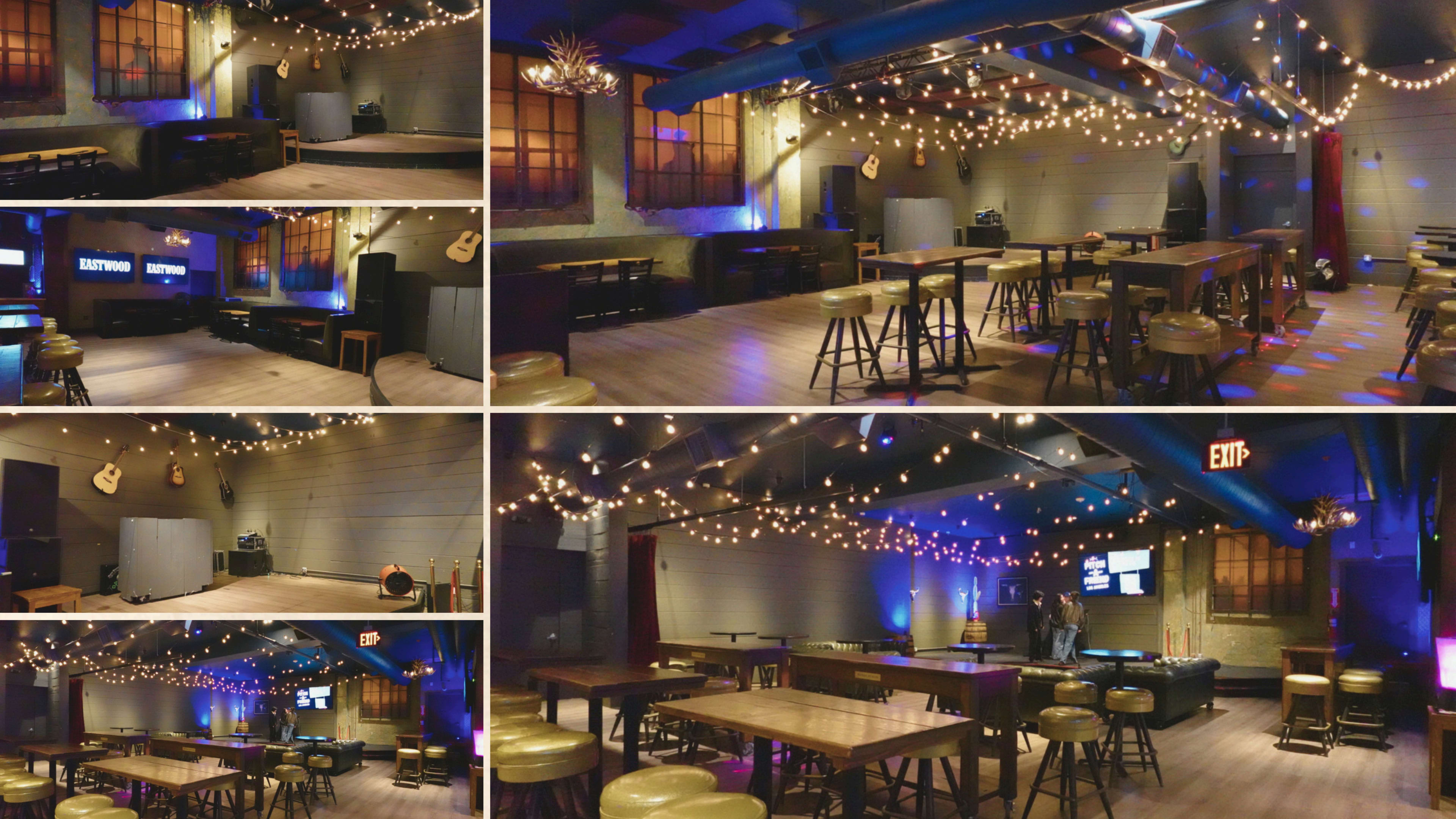 The image shows a spacious, dimly lit room designed for events, featuring wooden tables, bar stools, strings of decorative lights, and a stage area with sound equipment.