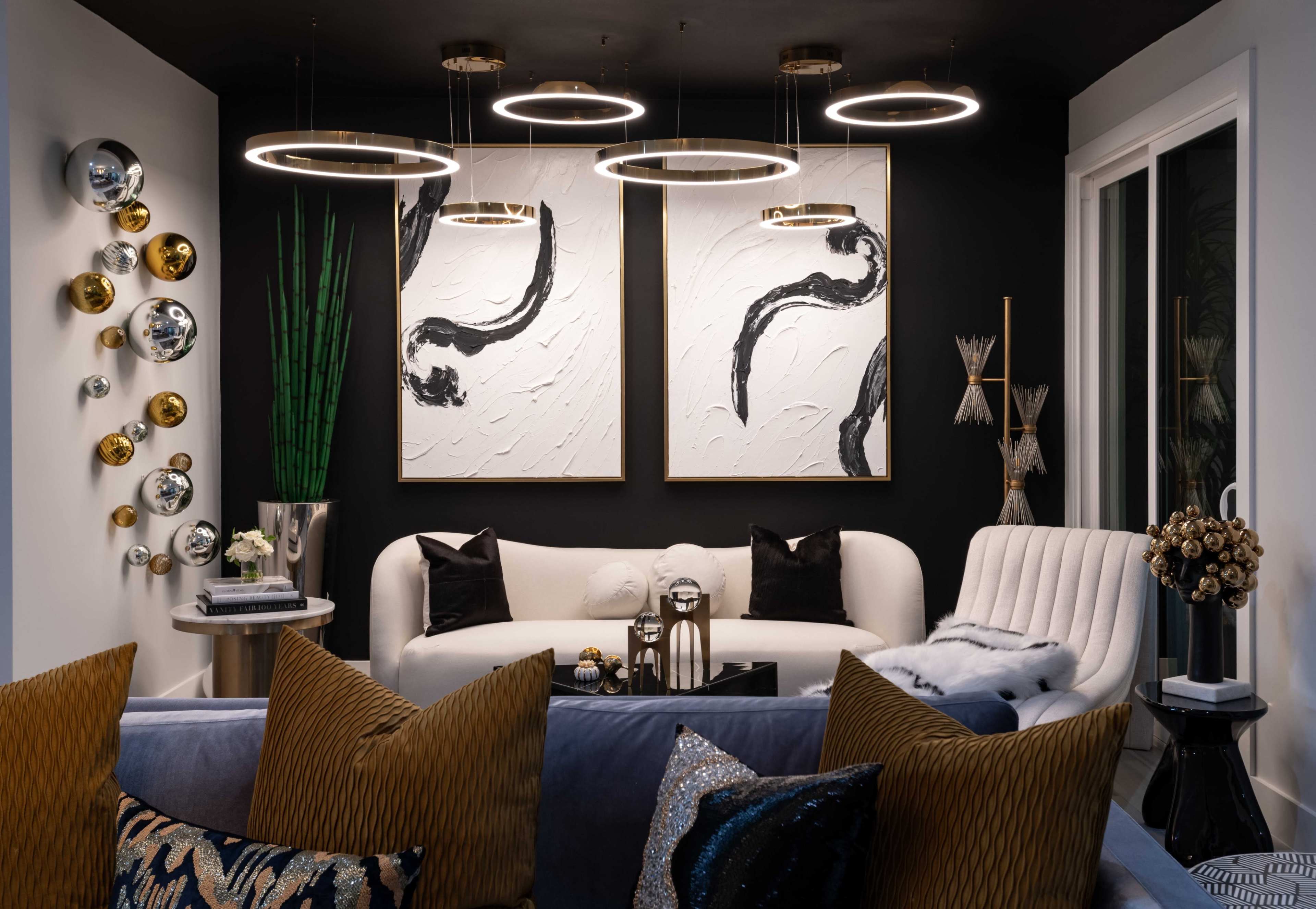 The image showcases a modern living room featuring a white sofa, artistic wall decor, and unique lighting fixtures.
