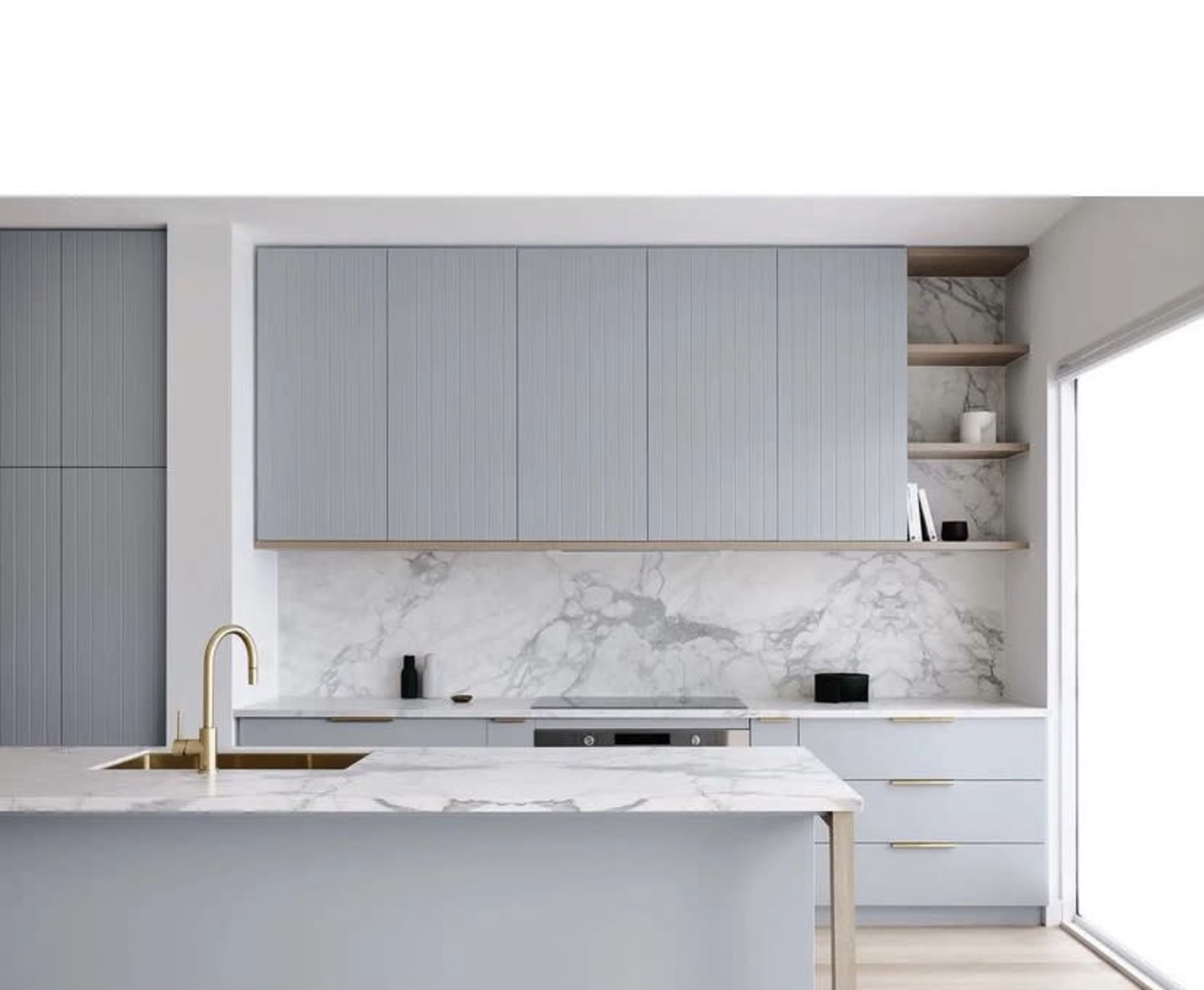 A modern kitchen with light blue cabinetry, marble countertops, and a marble backsplash.