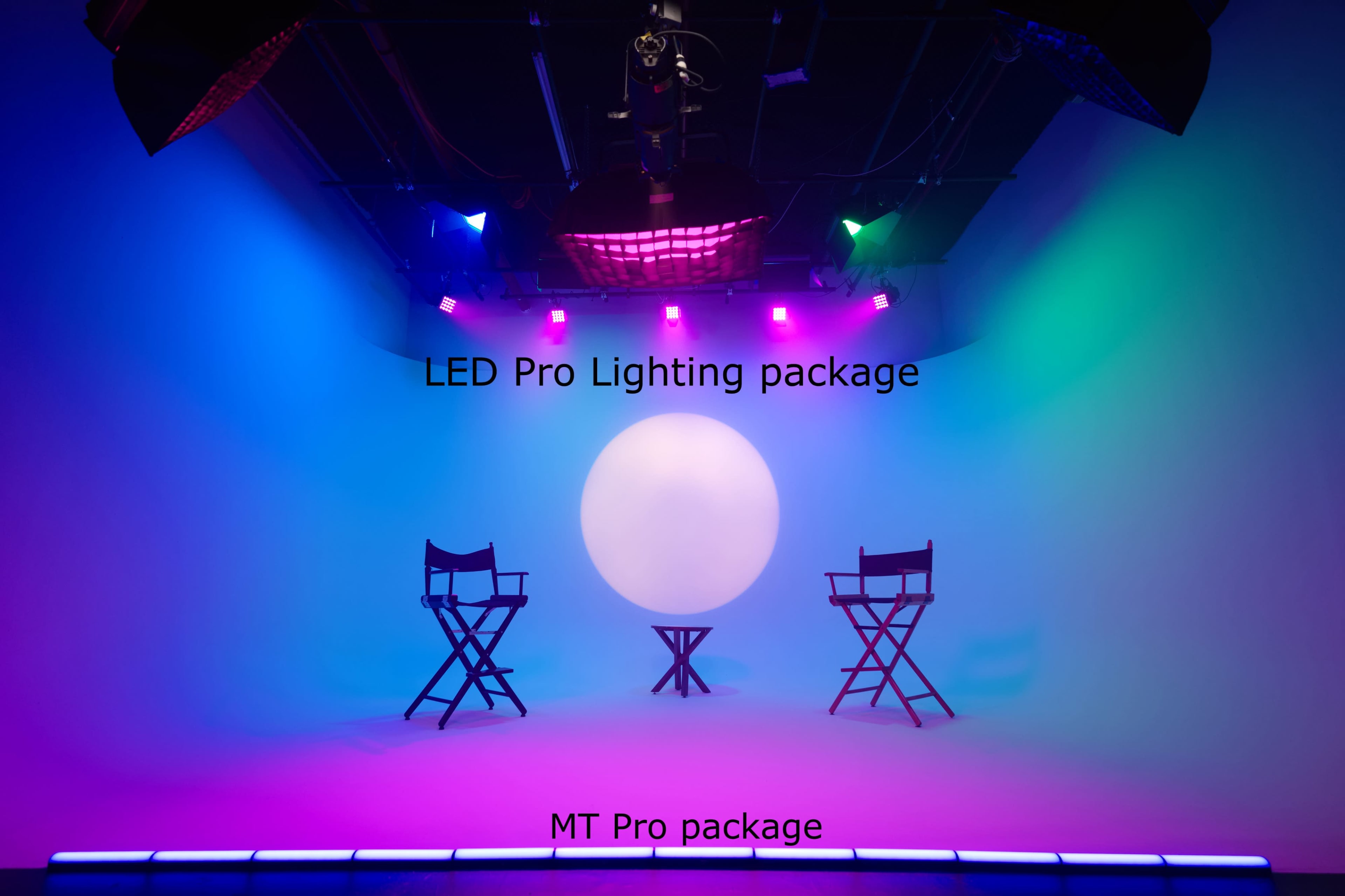 The image shows a studio setup with three director's chairs arranged around a large illuminated sphere, surrounded by colorful LED lighting.