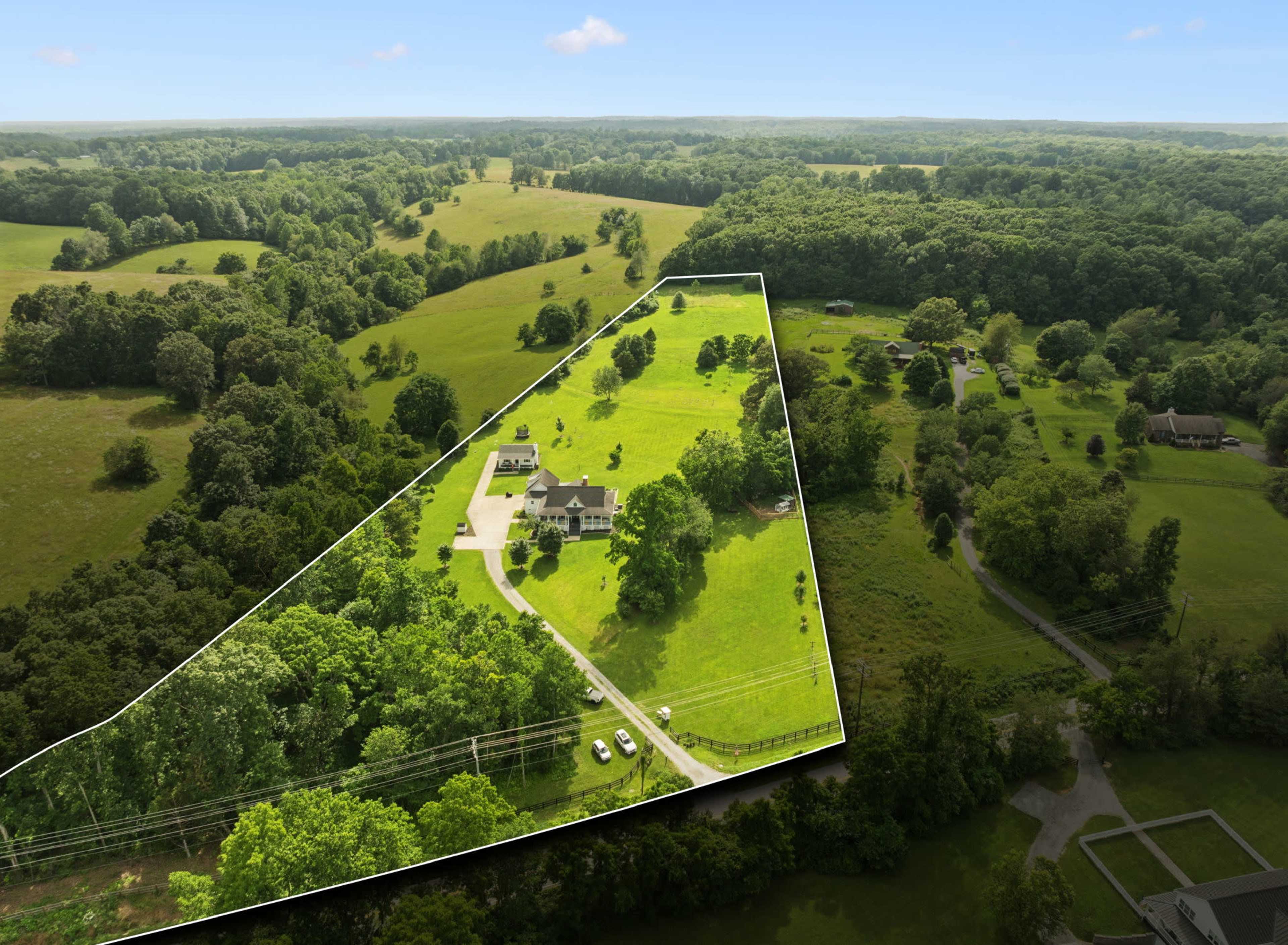 The image shows a large property with a house and surrounding greenery, bordered by farmland and trees, captured from an aerial perspective.