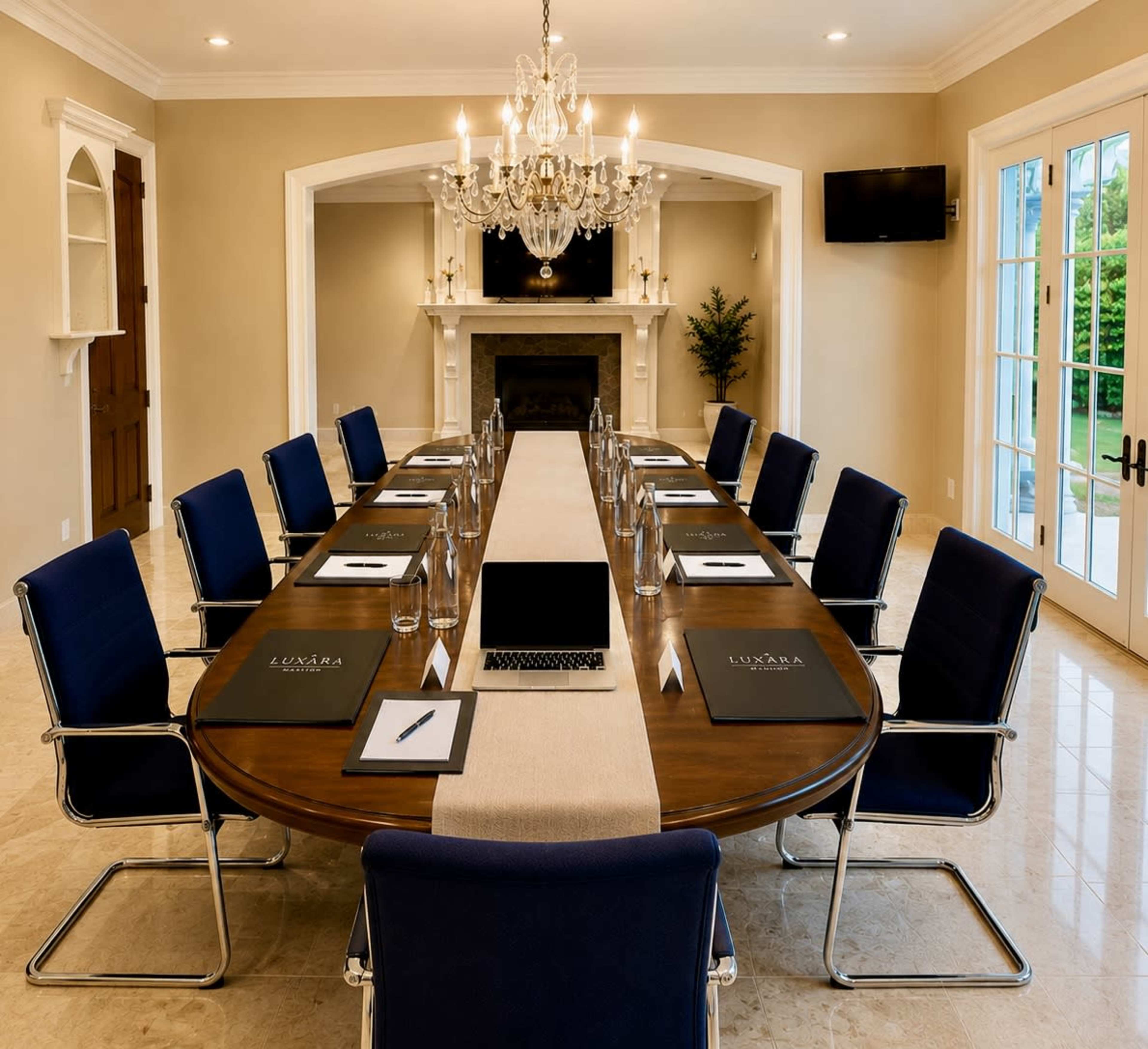 The image shows a well-lit conference room with a long wooden table set for a meeting, featuring twelve chairs, water glasses, notebooks, and a laptop arranged neatly along the center.