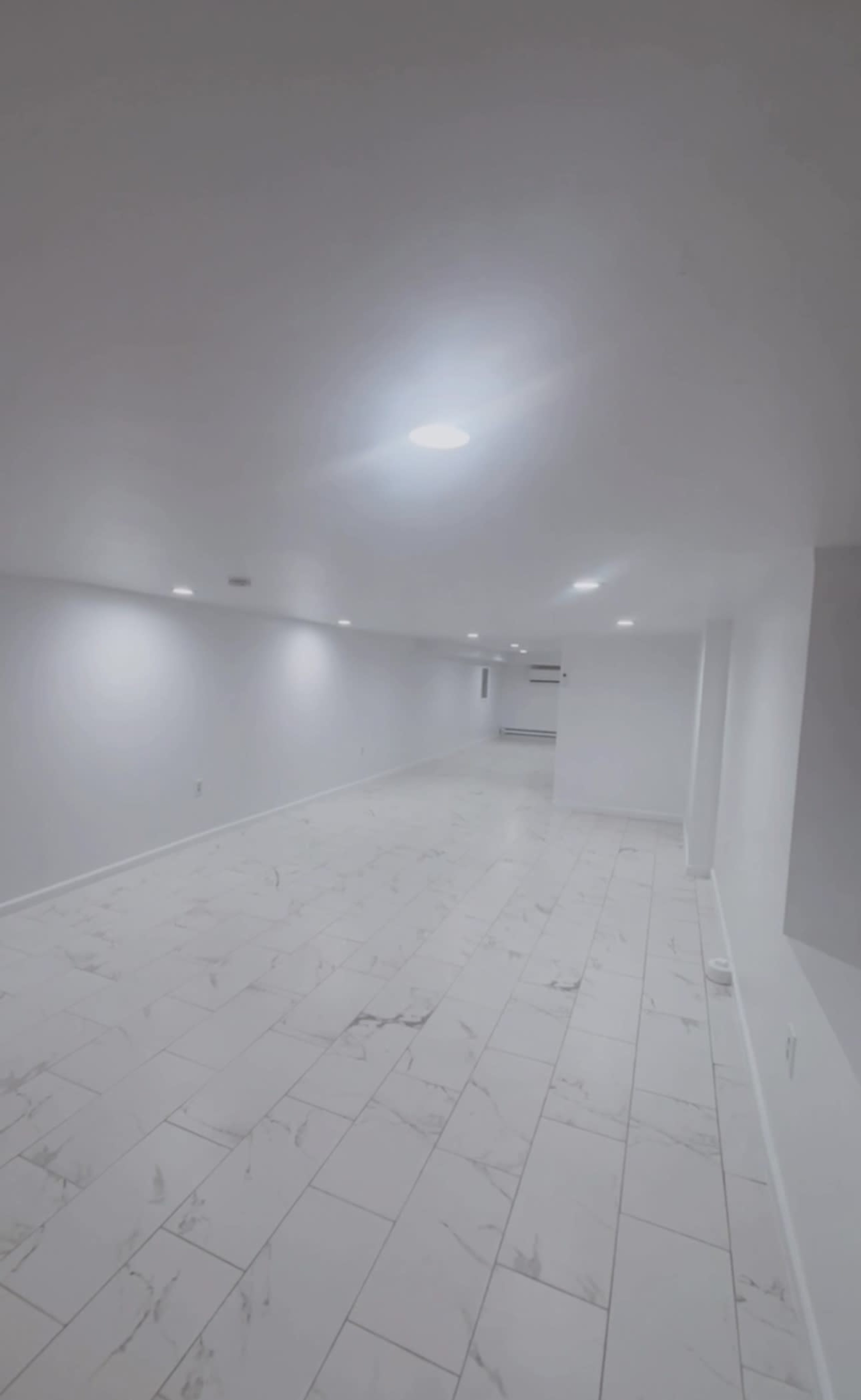 A modern elegant Event Space with white walls, gleaming white marble floors, and stunning customizable lighting, perfect for any occasion. Image in Kingsessing, Philadelphia, PA