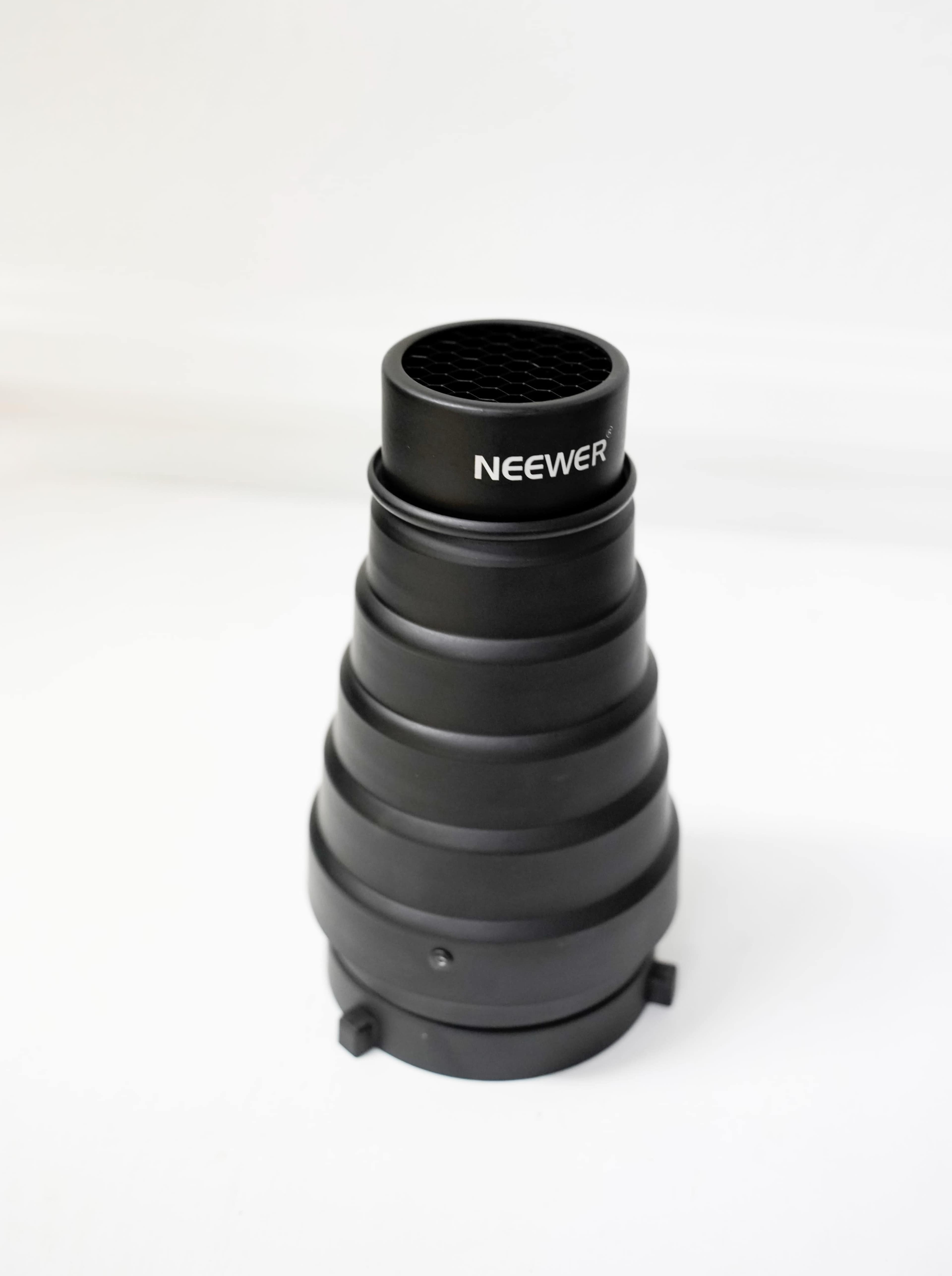A black Neewer collapsible softbox or reflector hood with a grid pattern at the top.