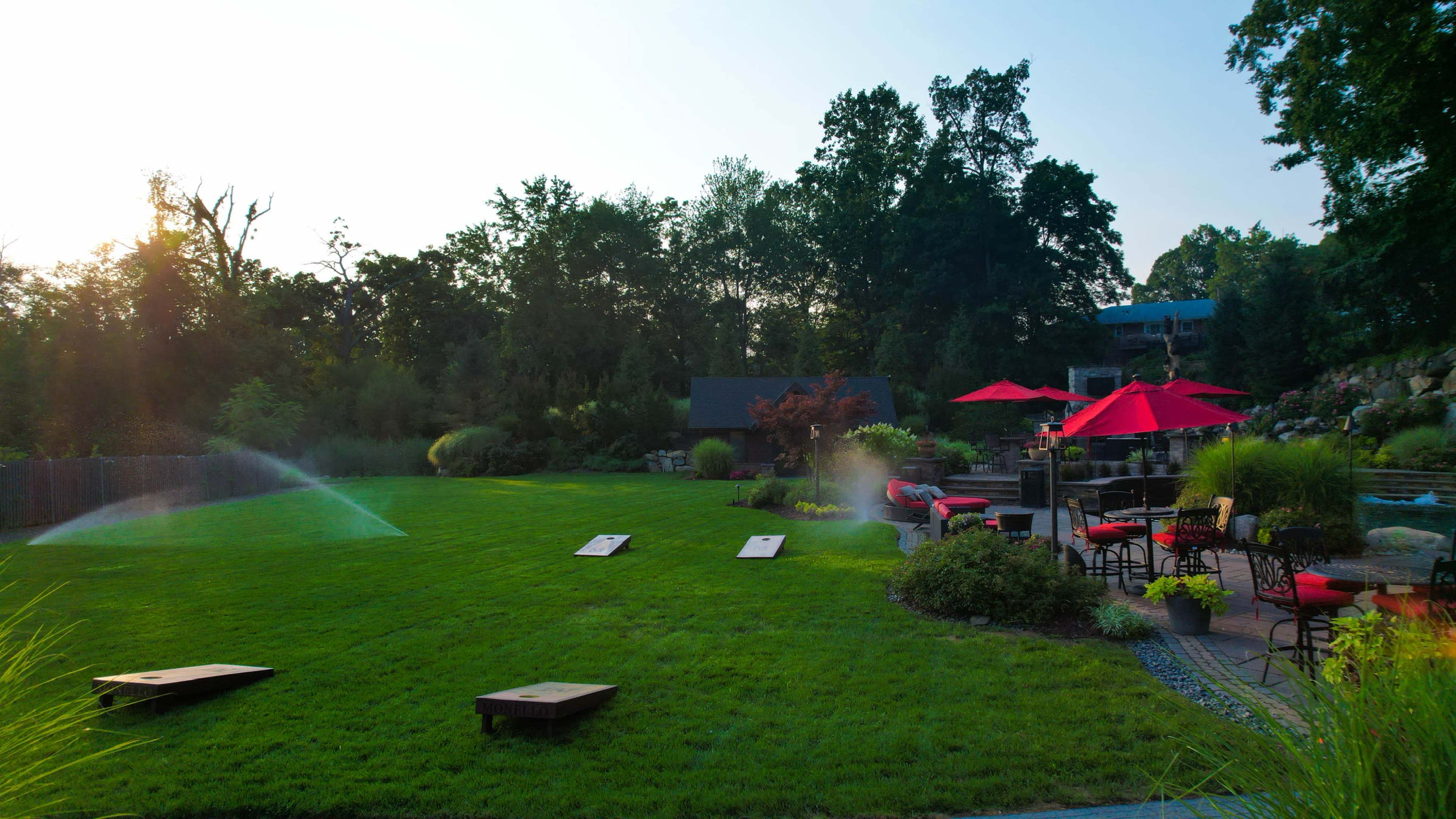 Luxury Resort-Style Backyard Oasis with Pool, Spa, Fire features, Koi pond, Outdoor Dining & entertaining Image in Pompton Plains, Wayne, NJ