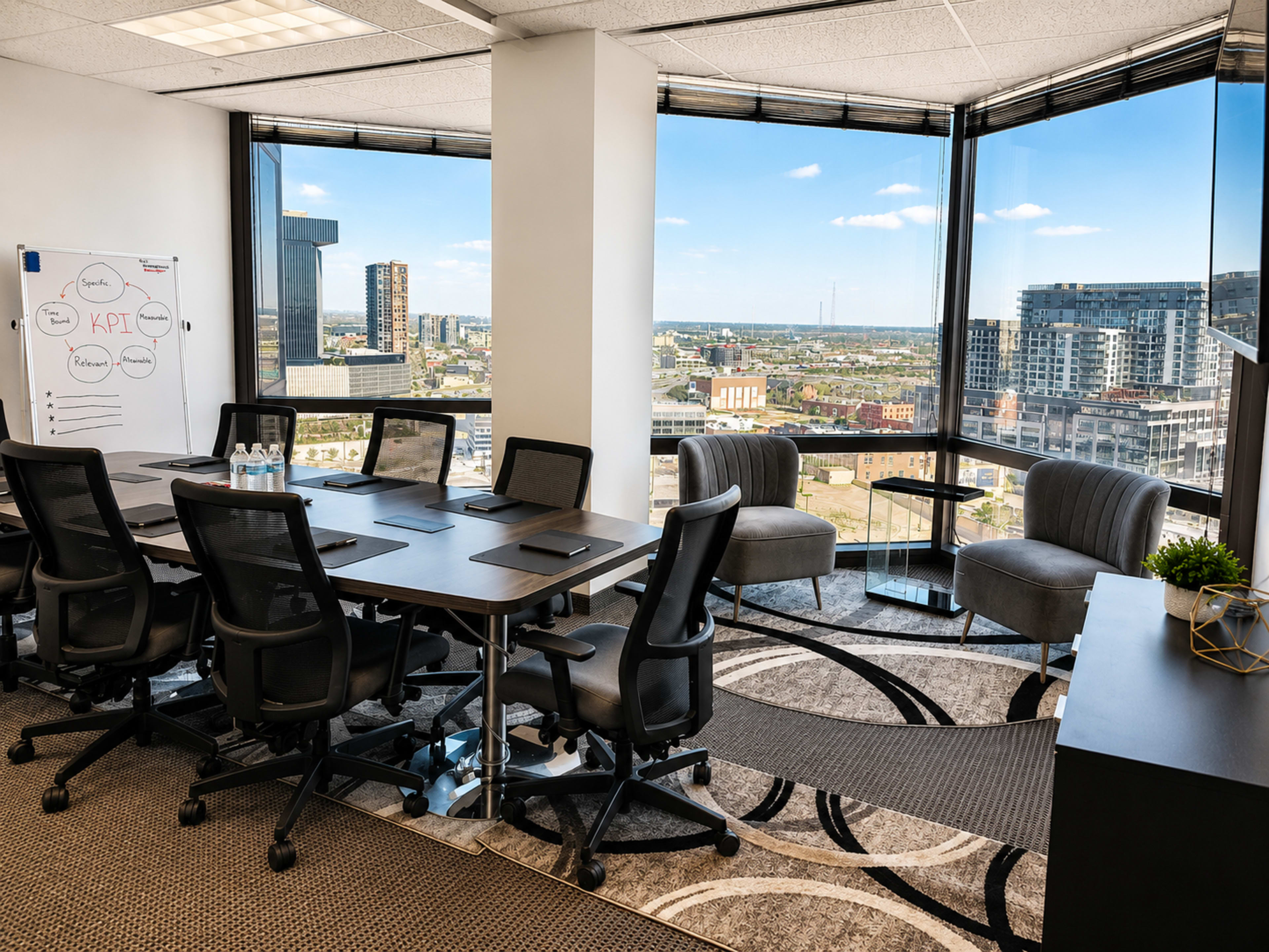 A modern conference room features a long table with chairs, a whiteboard, and large windows showcasing a cityscape.