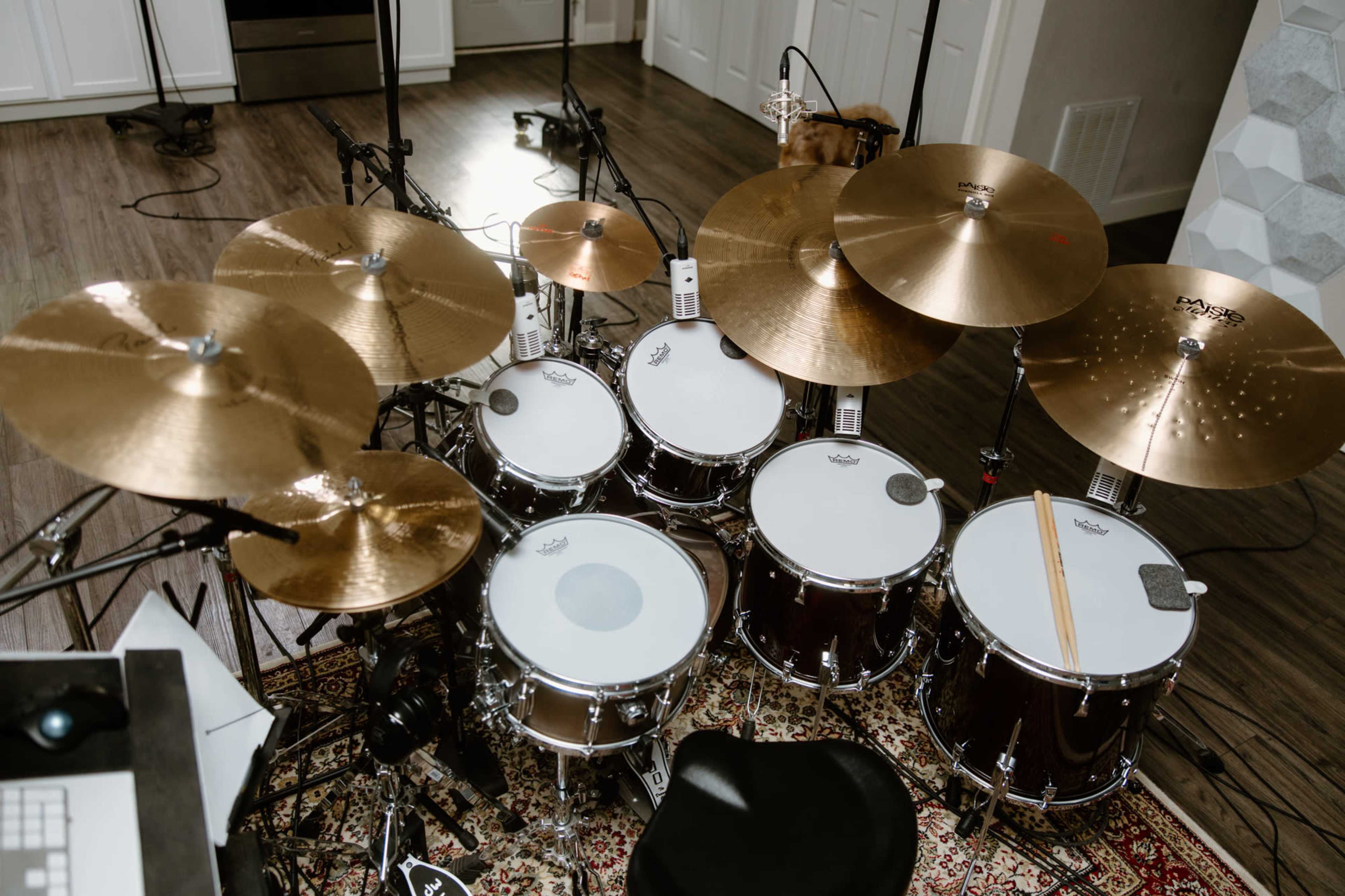 An overhead view of a drum set with multiple cymbals arranged around the tom-toms and snare drum.