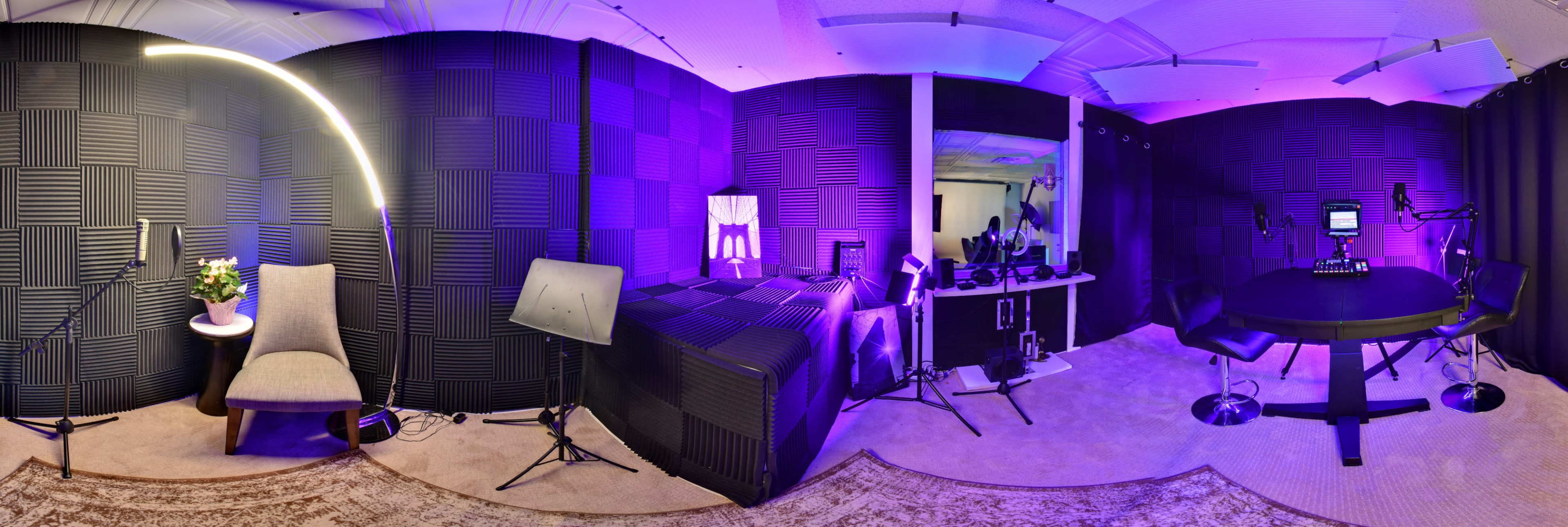 The image shows a soundproof recording studio with purple lighting, featuring a chair, microphones, and recording equipment.