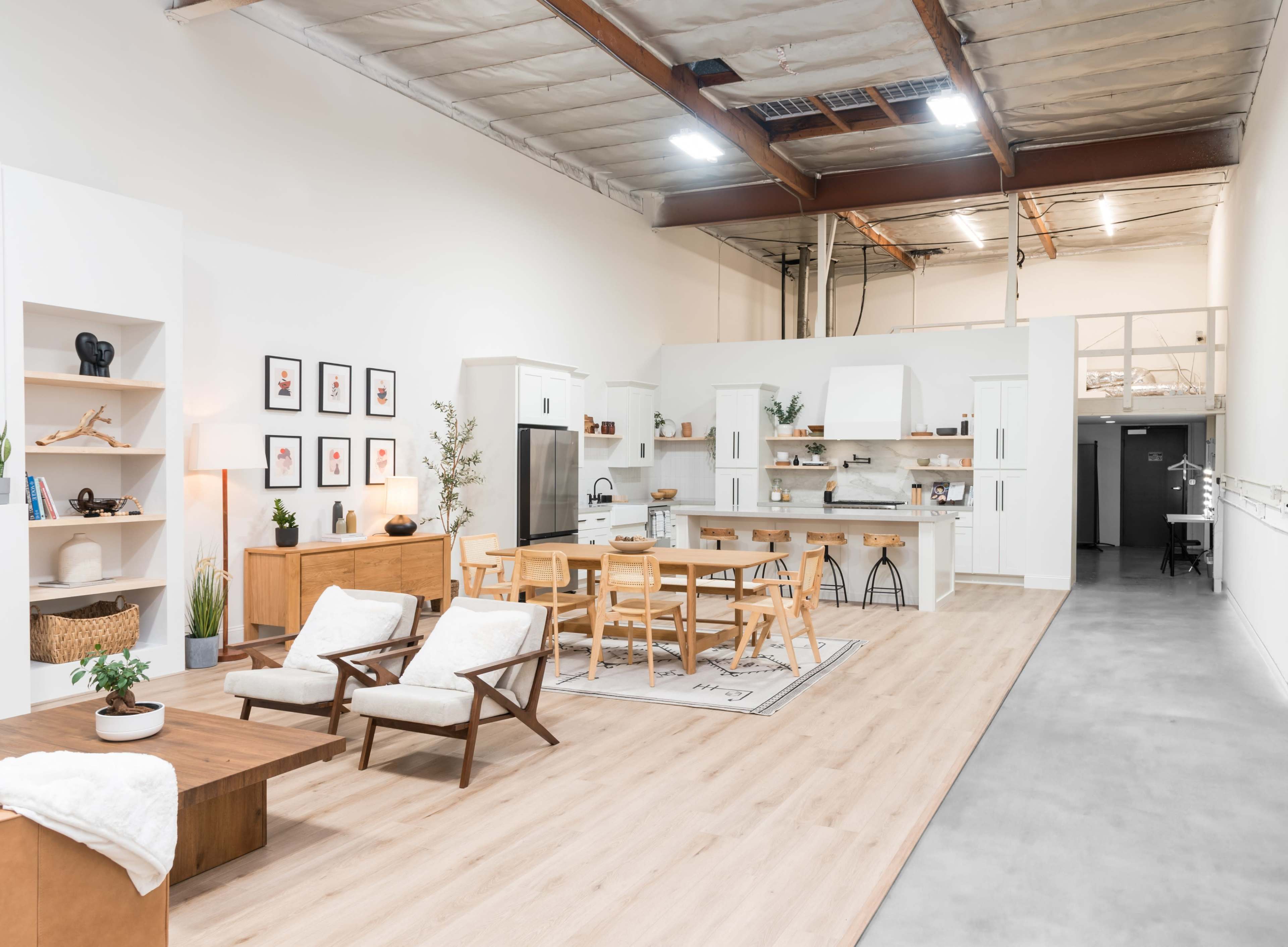 A spacious, modern open-concept kitchen and dining area with wooden furniture and a minimalist design.