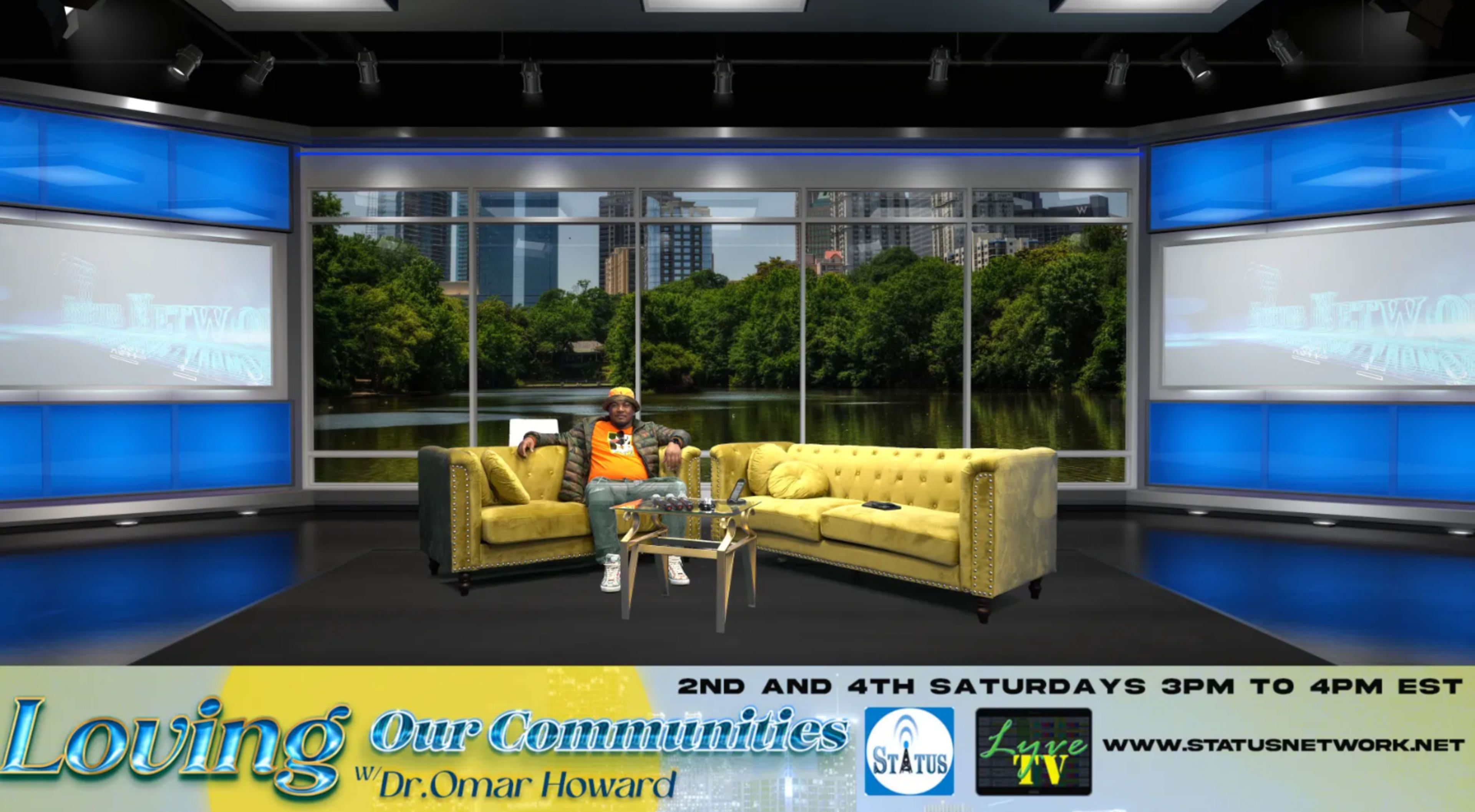 A man sits on a yellow sofa in a television studio with large screens displaying a nature backdrop and promotional text.