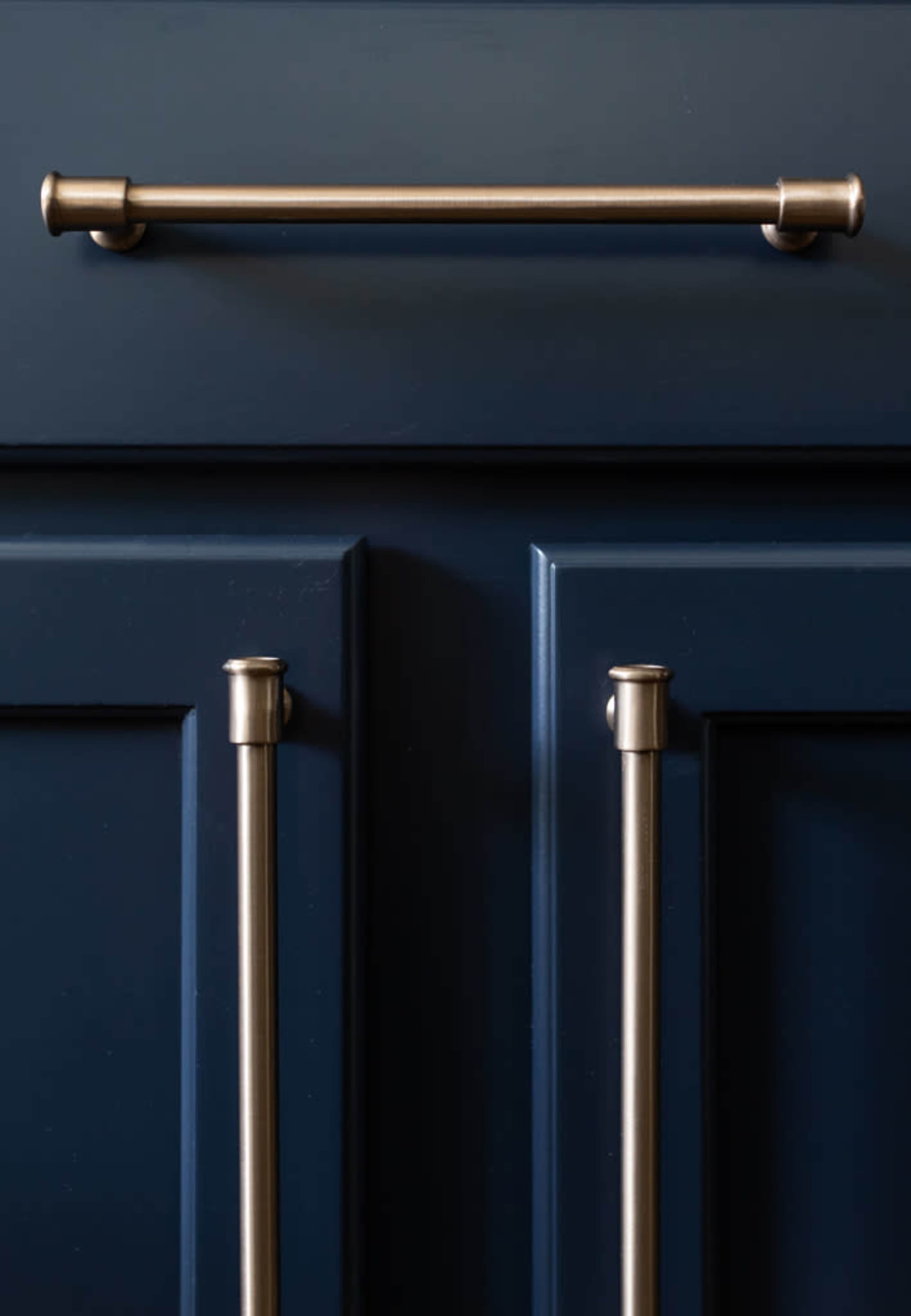 A navy blue cabinet with two vertical handles and a horizontal bar handle.